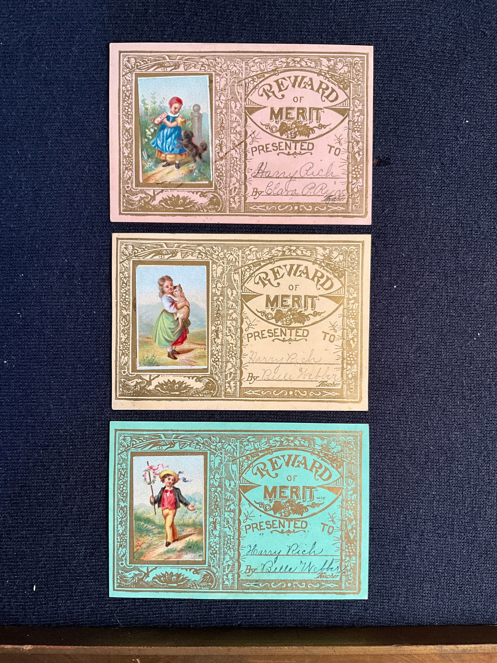 Rewards of Merit, ca. 1880s Lot of 3 - Matching Cards from a Set: Here are three 2 ½” 3 5/8” cards from a set. All given to a young scholar named Nancy Rich, ca. 1880. Printed in gold with added chromos. Very good condition.