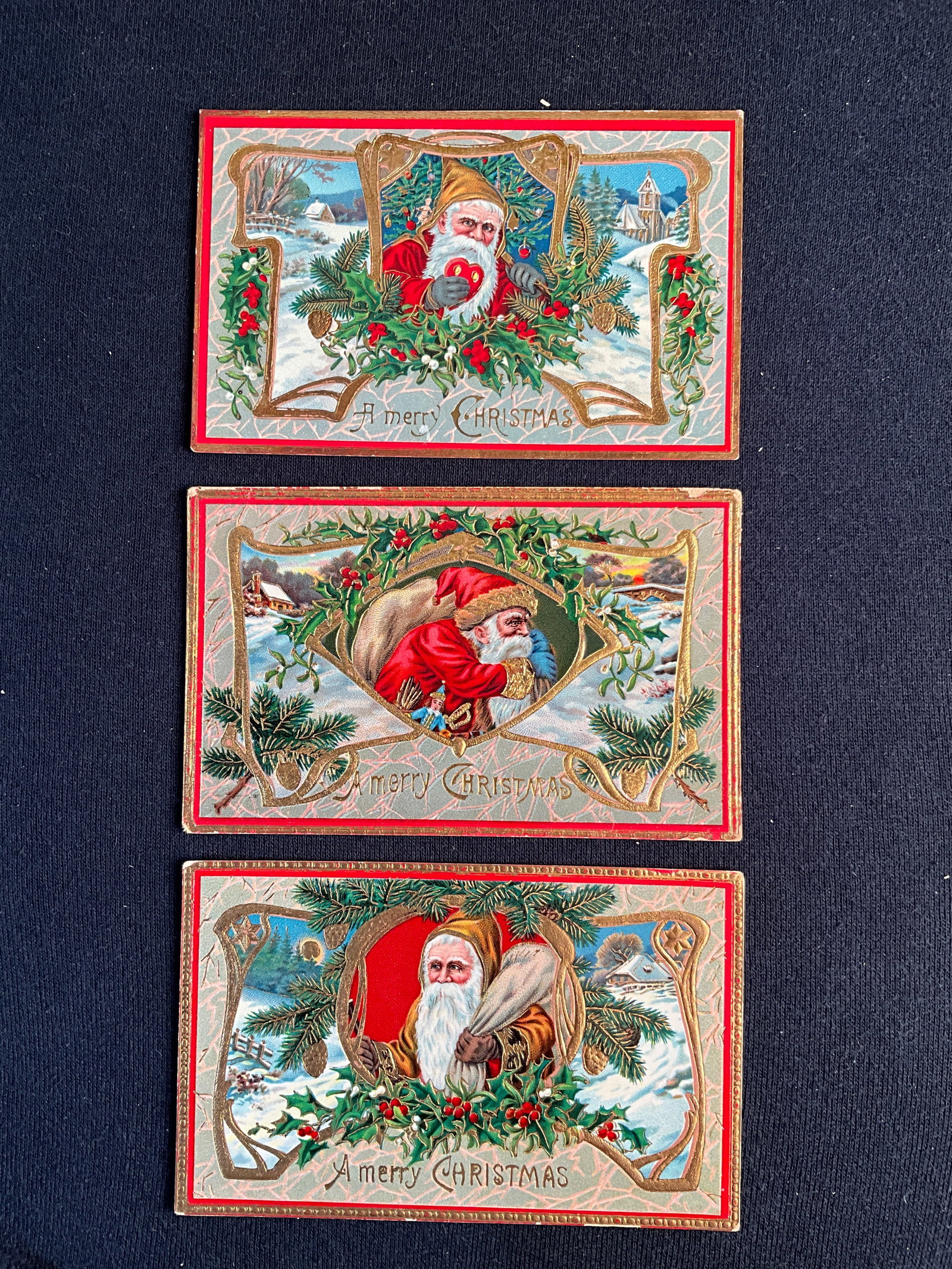 Post Cards, 1900-1915, - Santa's. 3 cards from a German Set: Santa's, 3 cards from a set printed in Germany; high gloss surface with gold highlights cards have normal, minor wear