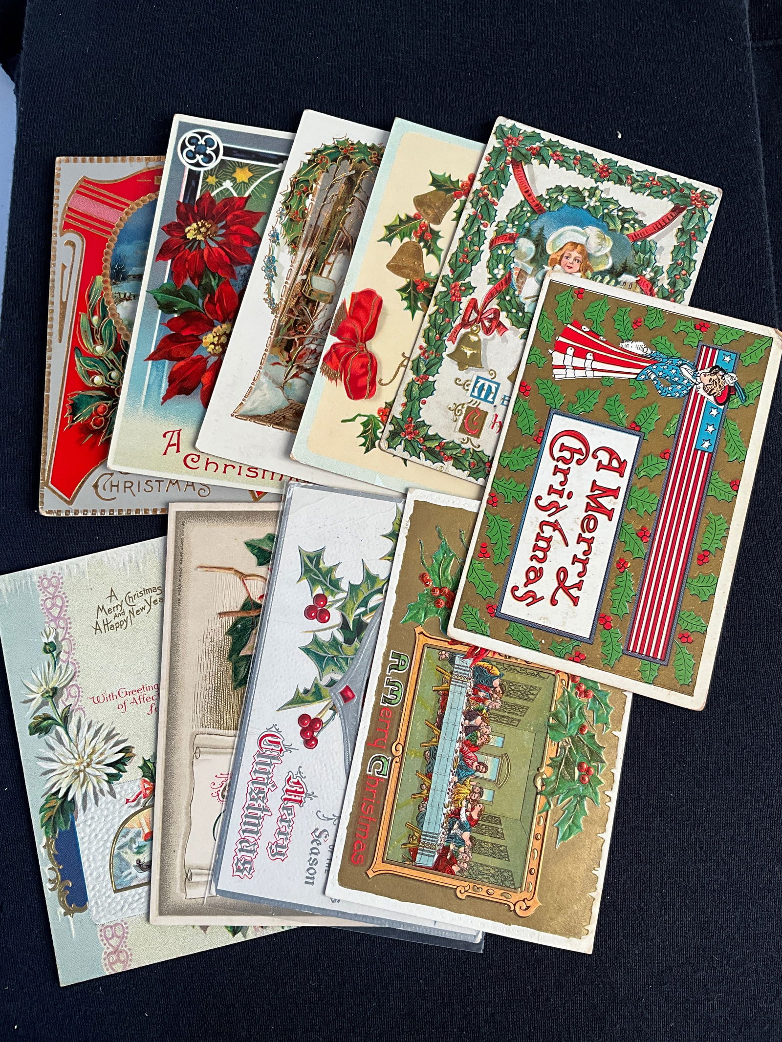 Post Cards, 1900-1915, Lot of 10 - Holly and Poinsettias Postcards: Ten Christmas cards depicting holly and poinsettias, dates ranging 1909-1915. Overall good condition; card with dog and cat has creases.