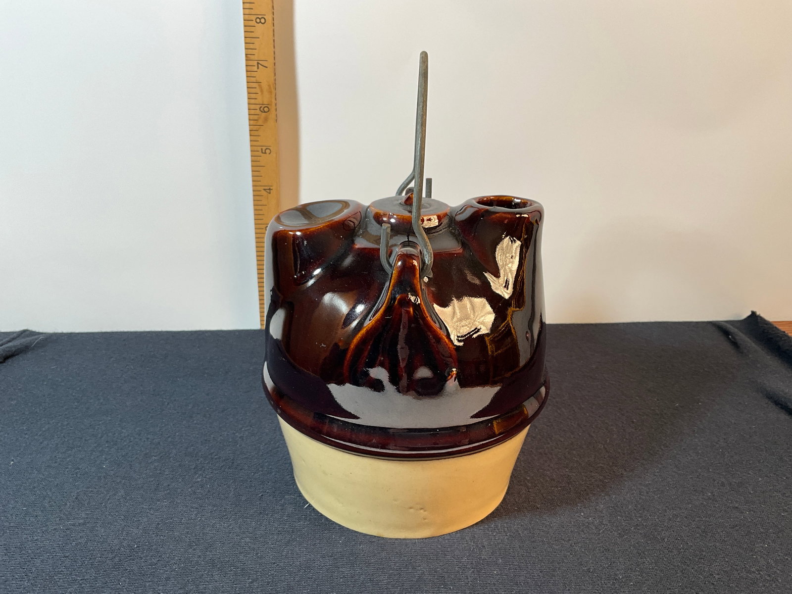 Stoneware Syrup Jar with Bale, Two-Tone Glaze, Tan and Brown: Stoneware syrup jar with bale. Two-tone with both tan and brown glaze. Probably holds a quart of everyone's favorite syrup. About 5 3/8" tall with a base diameter of 4". A hard-to-find container that