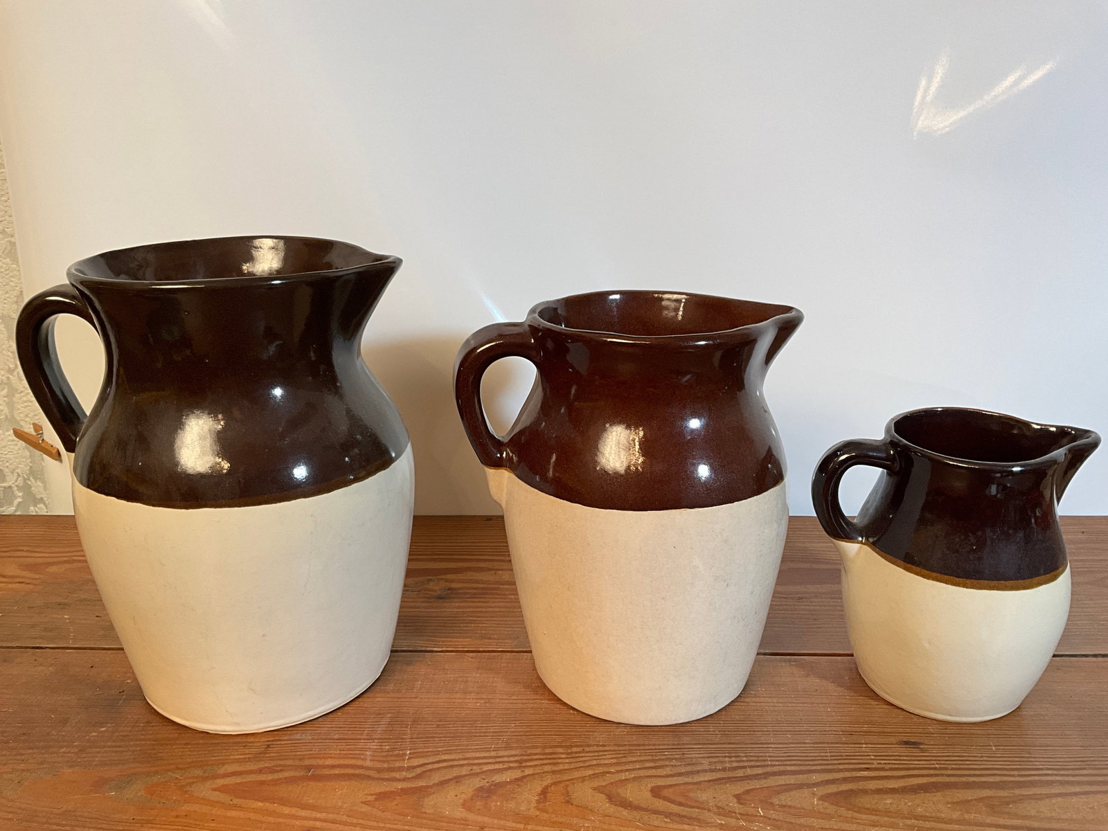 Lot of Three Different Sized brown and white potteryPitchers (1 of 8)