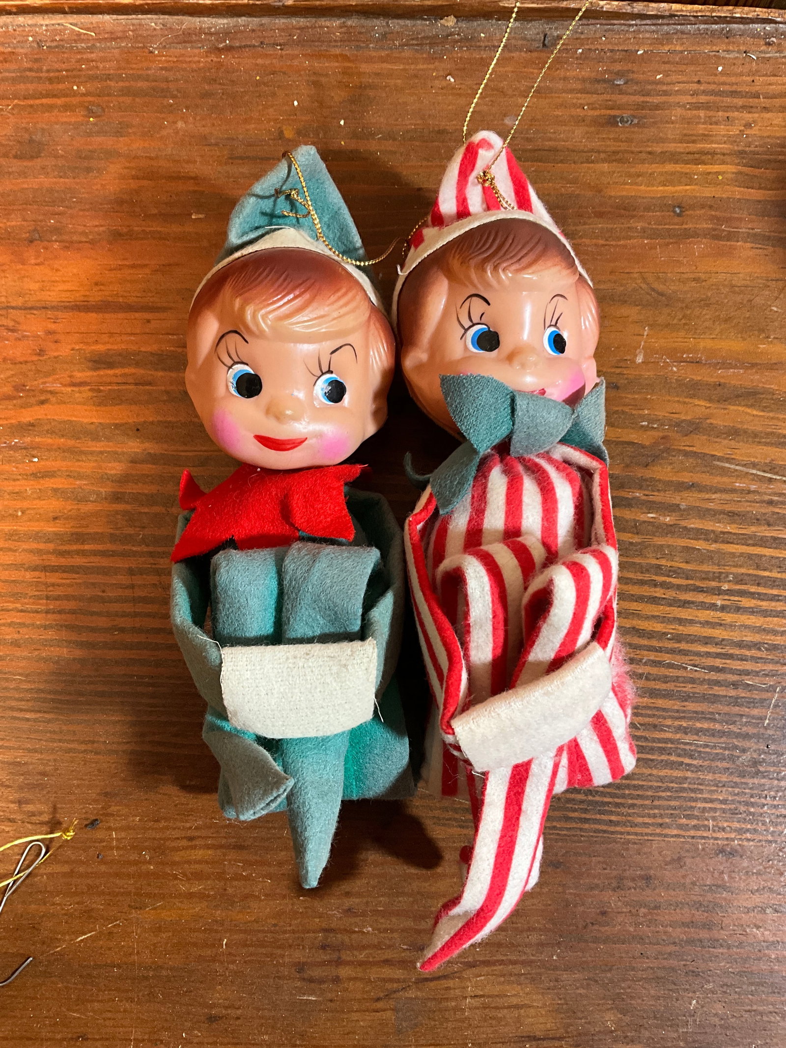 Vintage Pair of Knee Hugger Pixie Elves, Christmas Ornaments: Pair of knee-hugger elves. One in red and white stripes. The second elf is in green. If you are looking for an 'Elf on a Shelf,' this is a great place to start! Faces are very similar. The elves measu