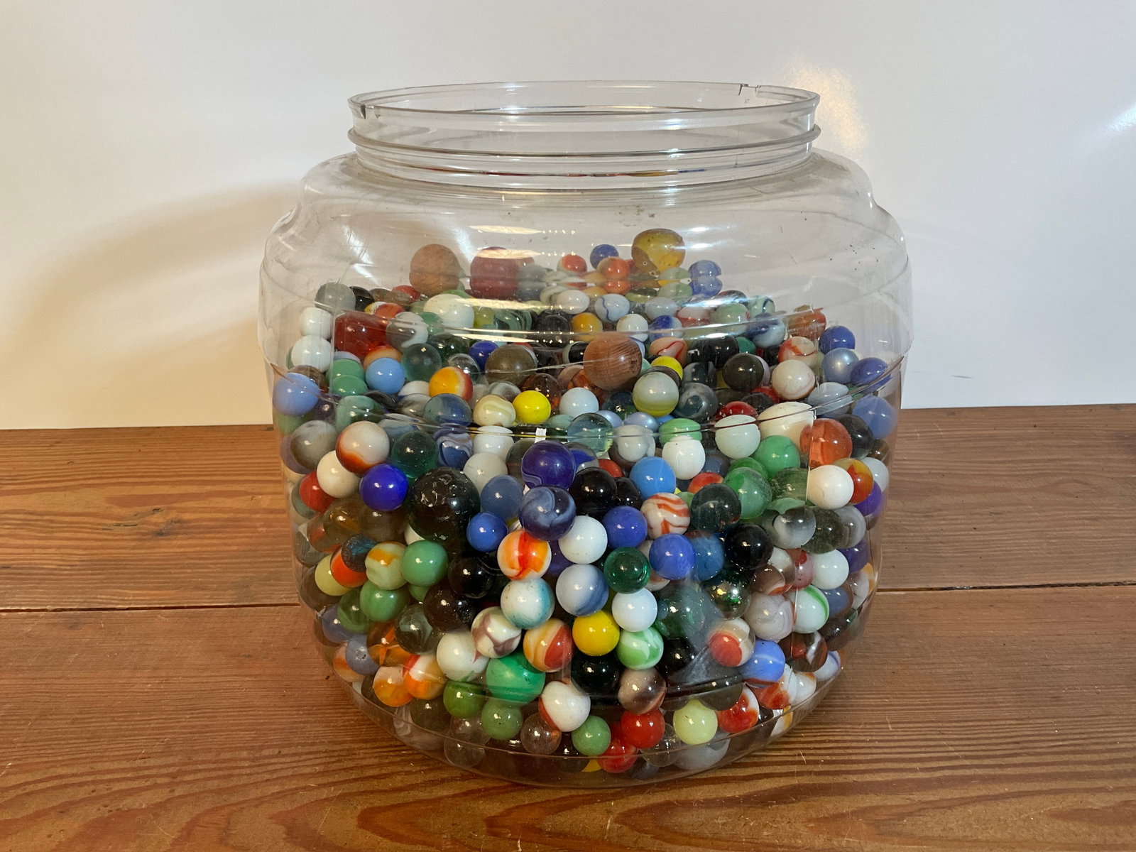 Lot of Marbles in Large Plastic Container, Akro Agate: Lot of Marbles. Many are Akro Agate. For reference, the plastic container that houses the marbles measures 9" tall by 9" wide. The marbles are at approximately the 5" mark inside the container. There