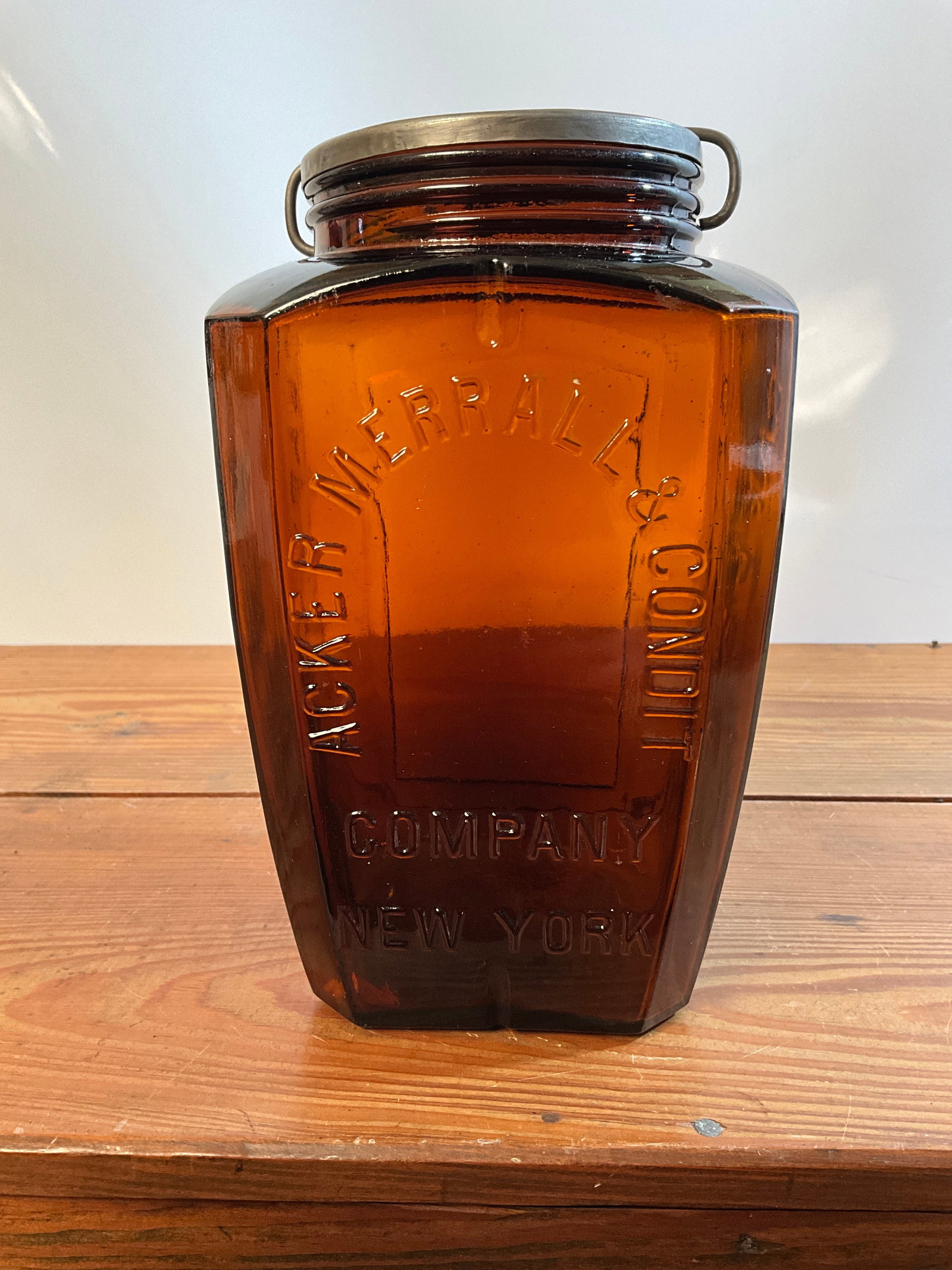Large Amber Acker Merrill & Condit Company New York W/ Orig. Lid, Cafe' De Luxe Tobacco Jar: Here is a RARE Large Amber Acker Merrill & Condit Company New York W/ Orig. Lid, Cafe' De Luxe Tobacco Jar. You don't see many of these. A great amber color, ground lip, no damage. IF this had a label