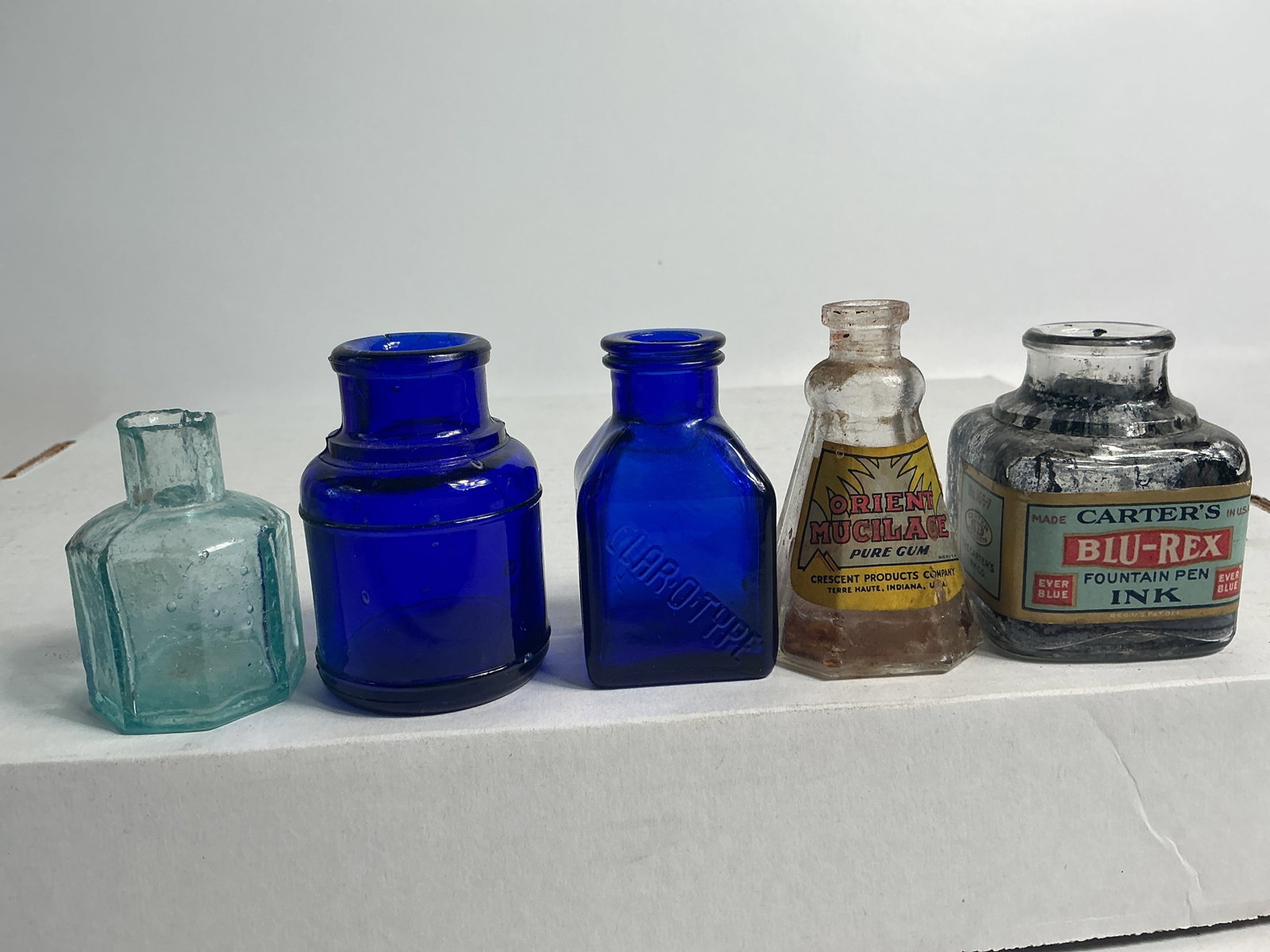 Group of 5 Inks: Here's a nice lot of 5 inks. The first is cobalt, square and embossed Clar-O-Type. The second is cobalt, round and unembossed. The third is clear, square and labeled Carter's Blu-Rex Ink. The fourth i