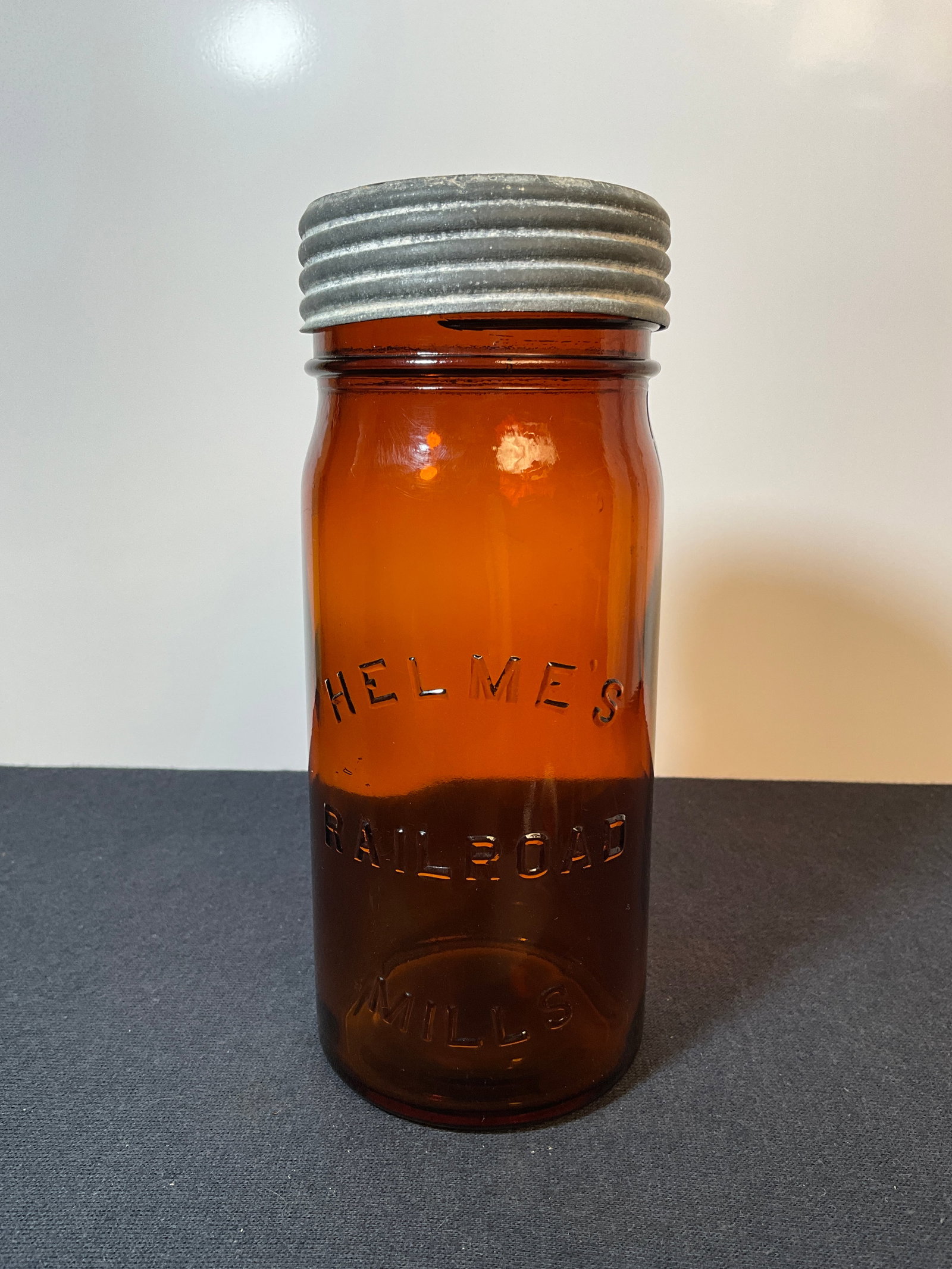Amber Helmes Railroad Mills Jar and Lid: Here is a UAmber Helmes Railroad Mills Jar and Lid, Original Closure included. A nice Snuff jar to go with your fruit jars or Railroad items.