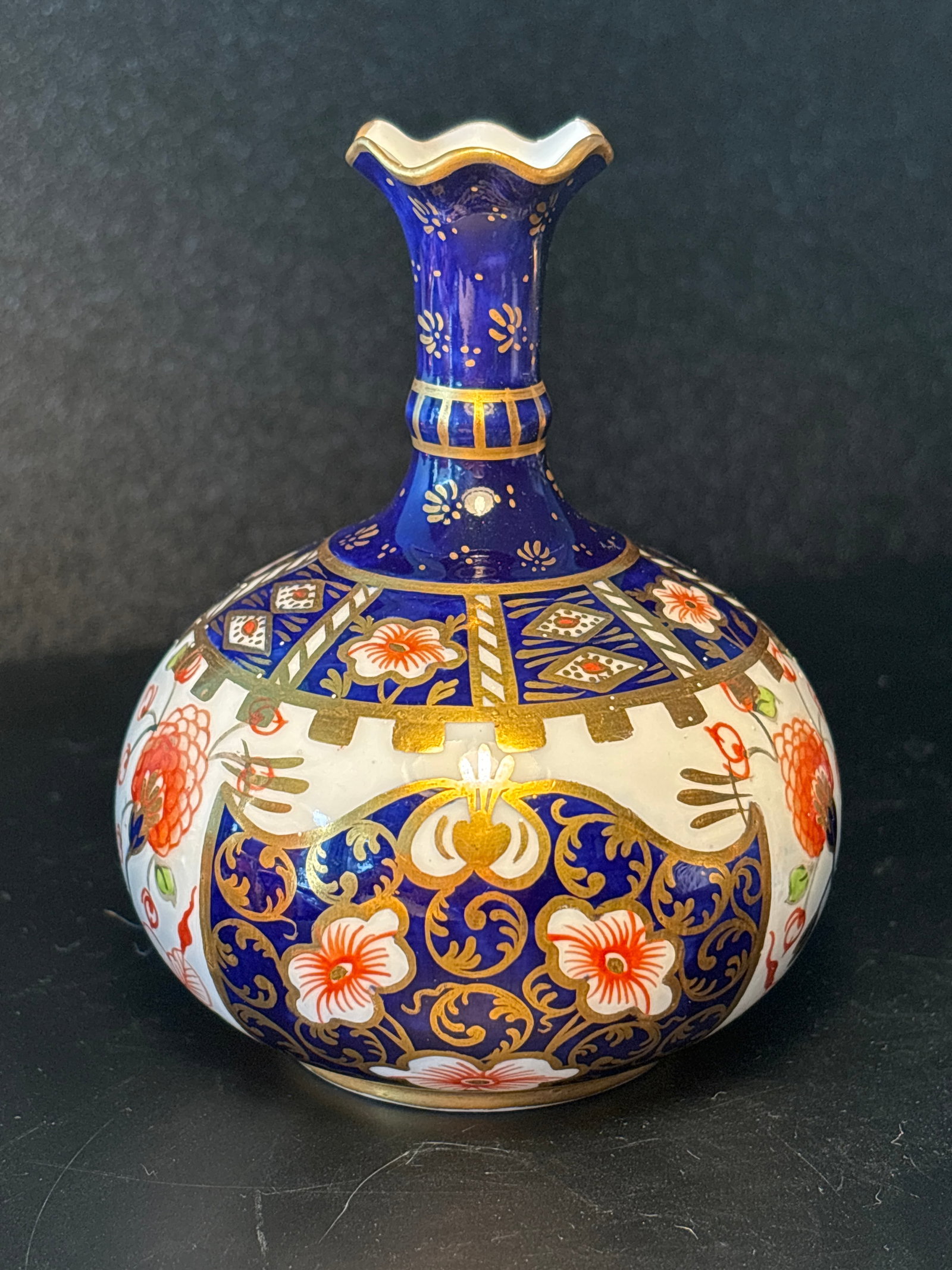 Code dated 1902 Small Royal Crown Derby Imari 6299 pattern globular vase, 9cm high: Royal Crown Derby Imari 6299 pattern globular vase, 4” ( 9cm ) high4” x3” x3”. Hand painted gold enamel accents.