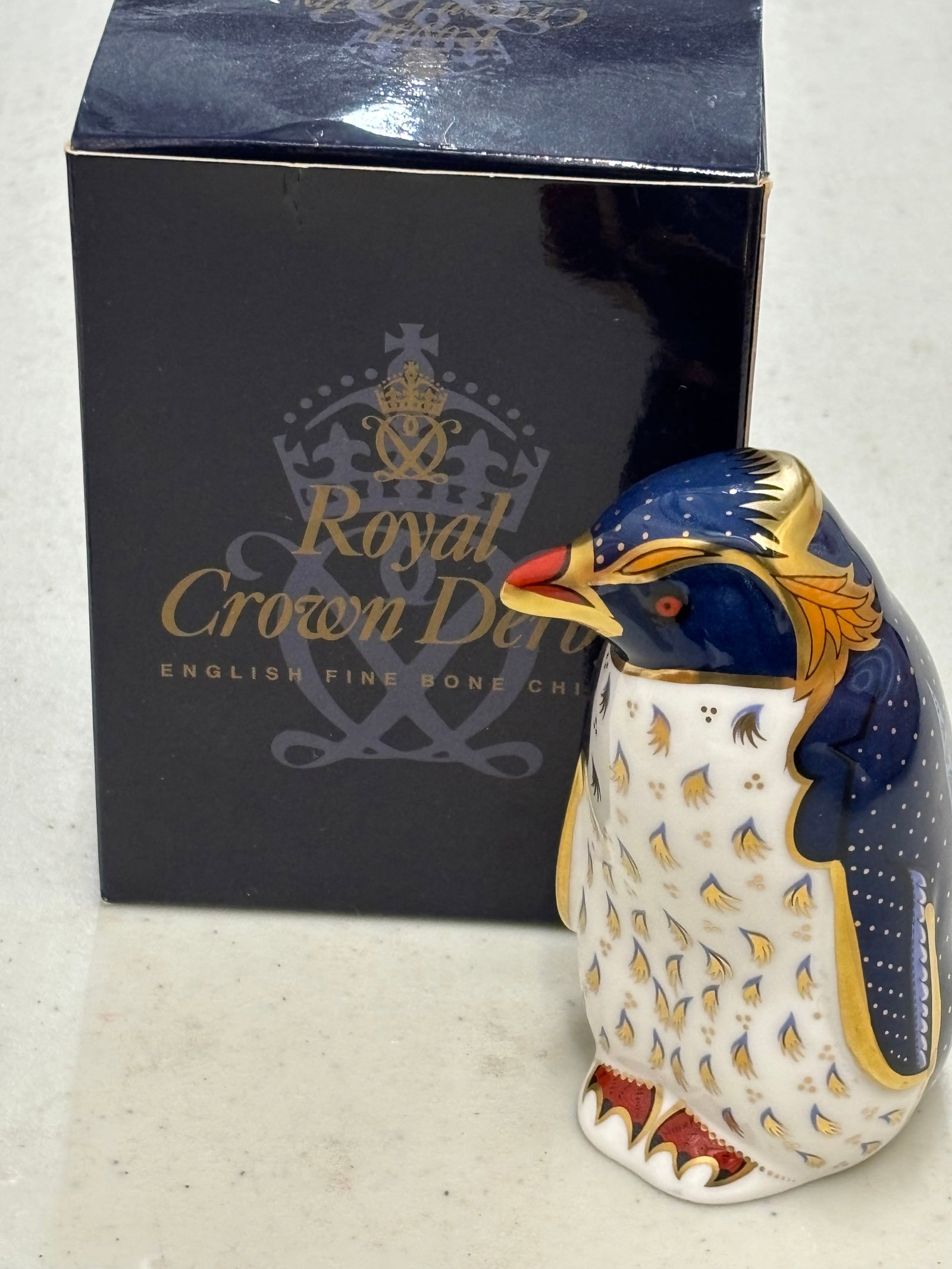 2002 Rock HopperPenguin Royal Crown Derby bone china 4&1/2 inch paperweight: 2002 Rock Hopper Royal Crown Derby paperweight . About 4&1:3 inches. Gold stopper. With box.Very good estate condition..