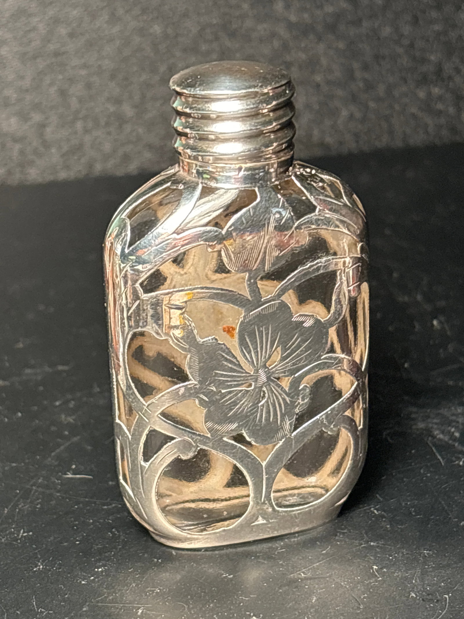 Small Art Nouveau Sterling overlay cut glass 3,inch perfume with screw top sterling lid: Art Nouveau Sterling overlay cut glass 3 inch perfume with screw top sterling lid. Flattened ovoid shape. Marked 925 fine silver on bottom edge. Monogram.