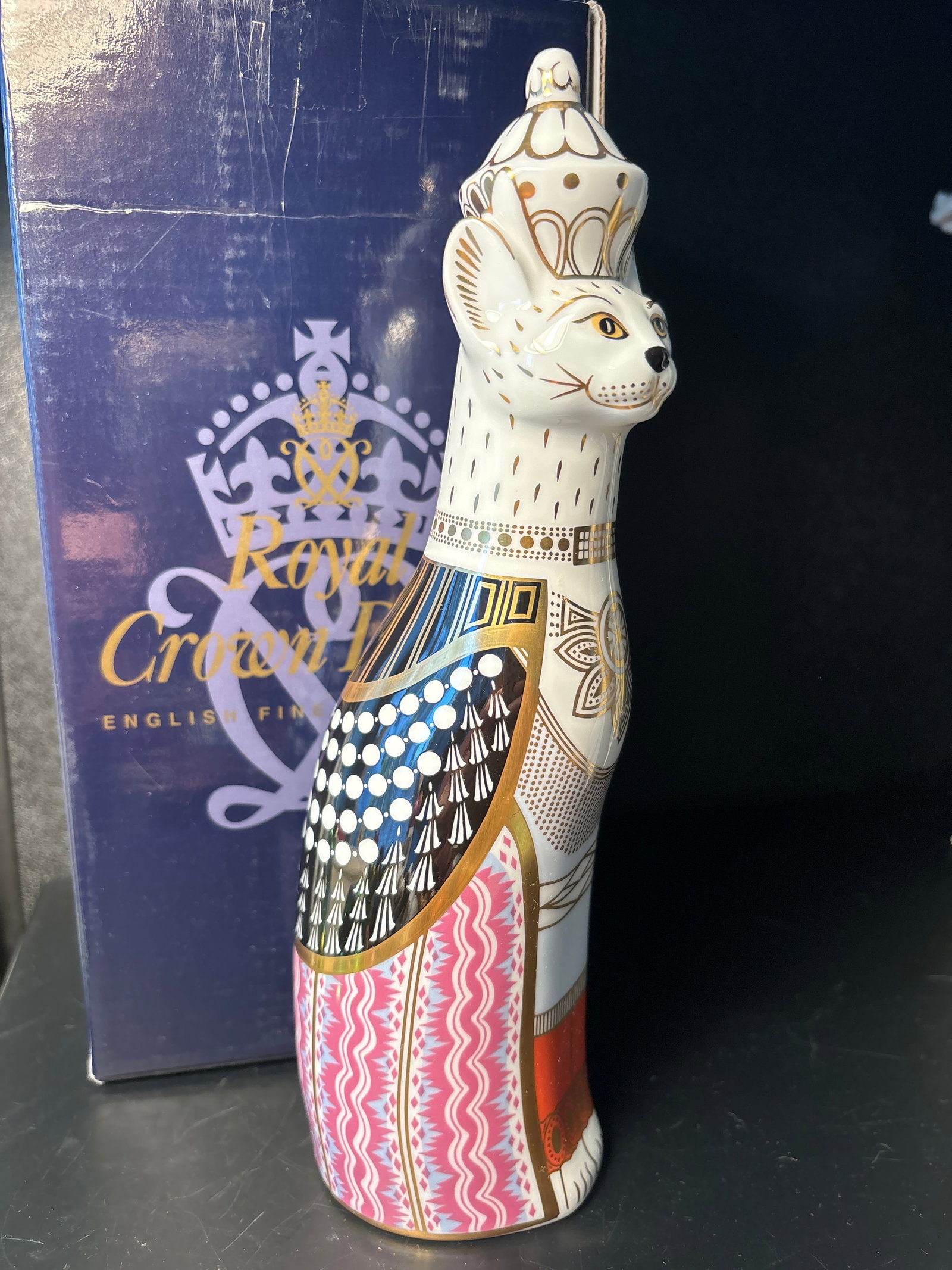 Very tall 9 in. Royal Crown Derby English fine bone china Burmese Royal Cat w/box: 9” tall by 3” at widest.The Royal Cat collection of Royal Crown Derby depicting a Burmese cat with crown. Excellent quality. These are hand painted in England.With original box.Very good c