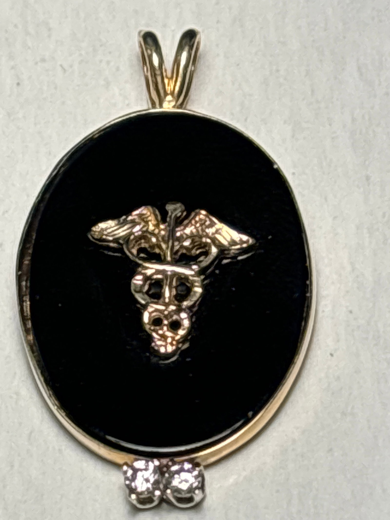 Vintage 14k gold & onyx pendant w/diamonds caduceus symbol, 1&7/8in: Vintage 14k gold & onyx pendant w/diamonds caduceus symbol, 1&3/8 inch x 5/8 inch wide.Solid 14 k gold marked on back as well as “ King”.Very good condition.