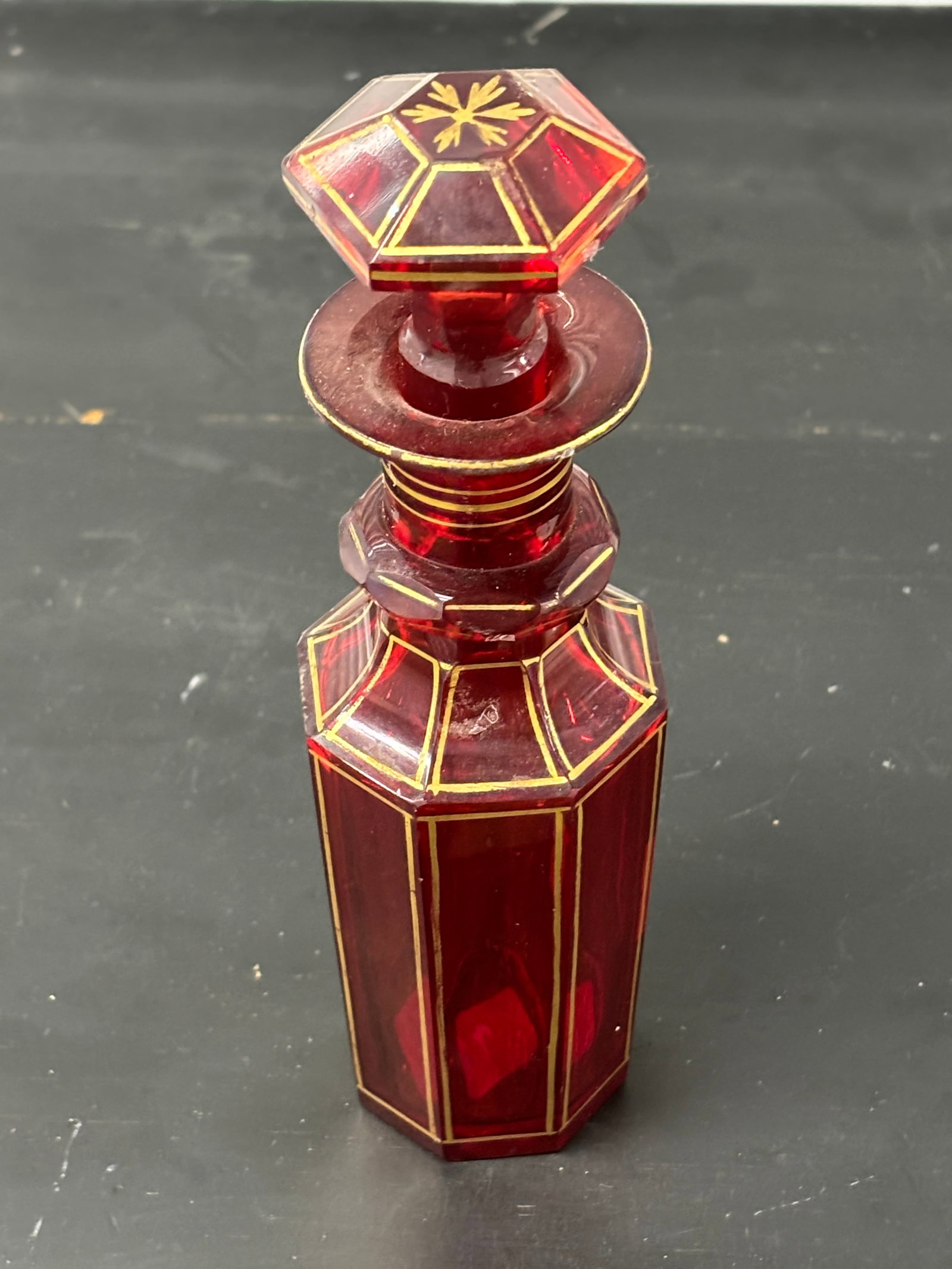 Victorian Bohemian red art glass 7 inch perfume bottle w/stopper: Victorian Bohemian red art glass 7 inch perfume bottle w/stopper. Some minor chips to edge and gold loss.Good clean estate condition