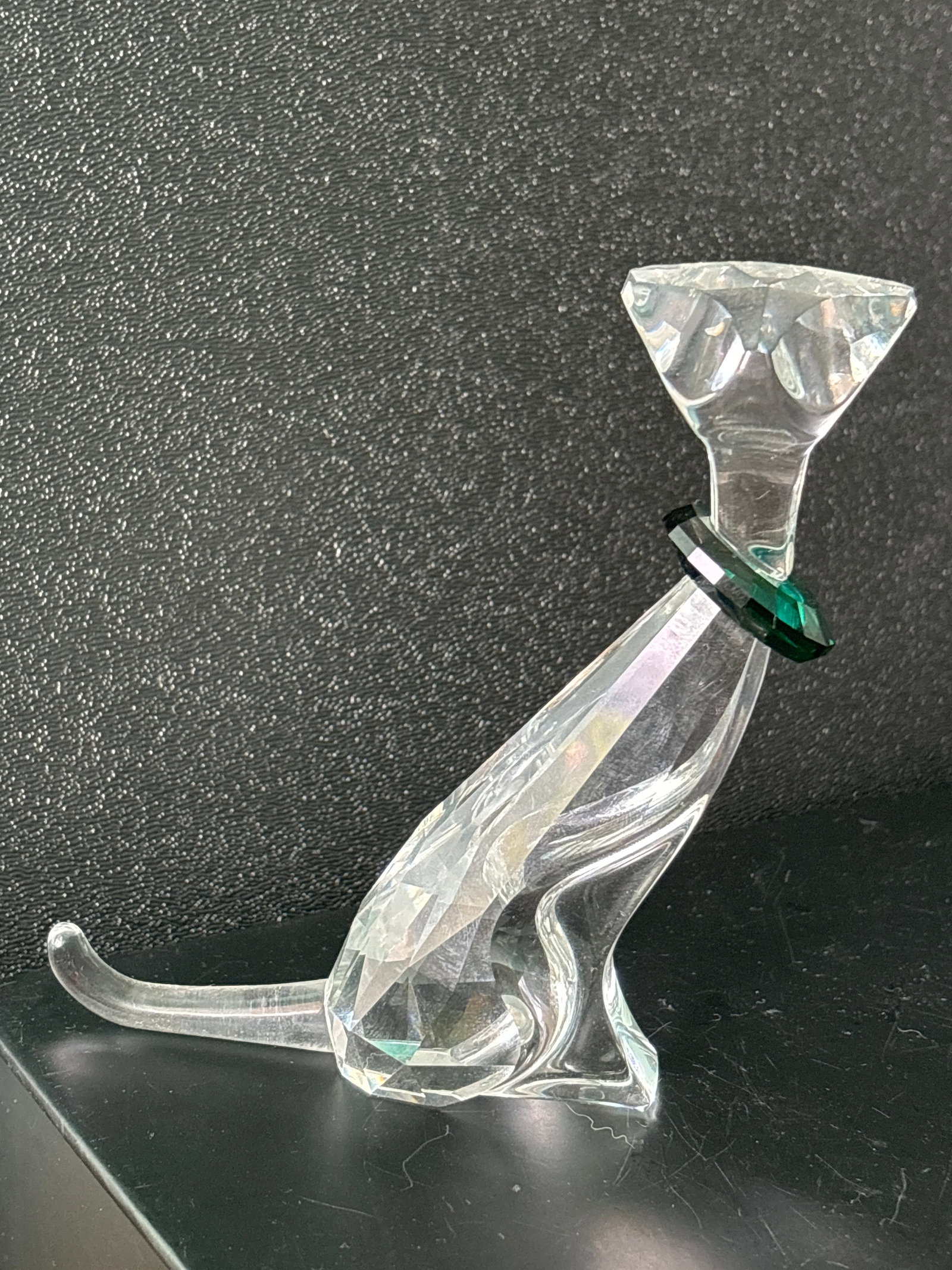 Tall 5 inch Swarovski cat crystal statue with emerald glass collar: Tall 5 inch Swarovski cat crystal statue with emerald glass collar.statue.Signed on bottom. It is about inches tall by 4 inches wide.Good condition