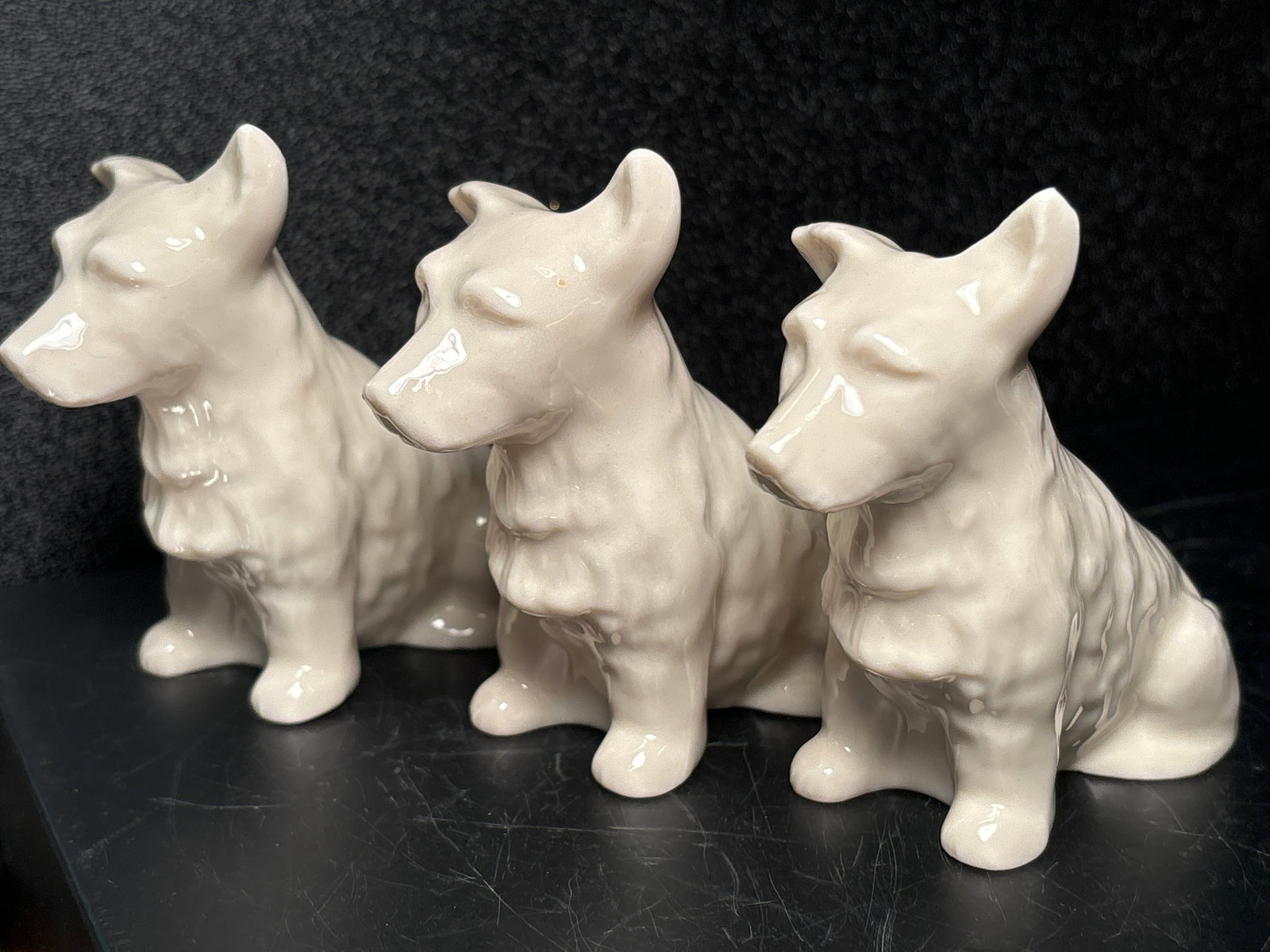 Three dogs Green mark Irish Belleek bone china 4&1/2x4 inch figurines: Three Green mark Irish Belleek bone china dogs figurines.Good condition with no damage.