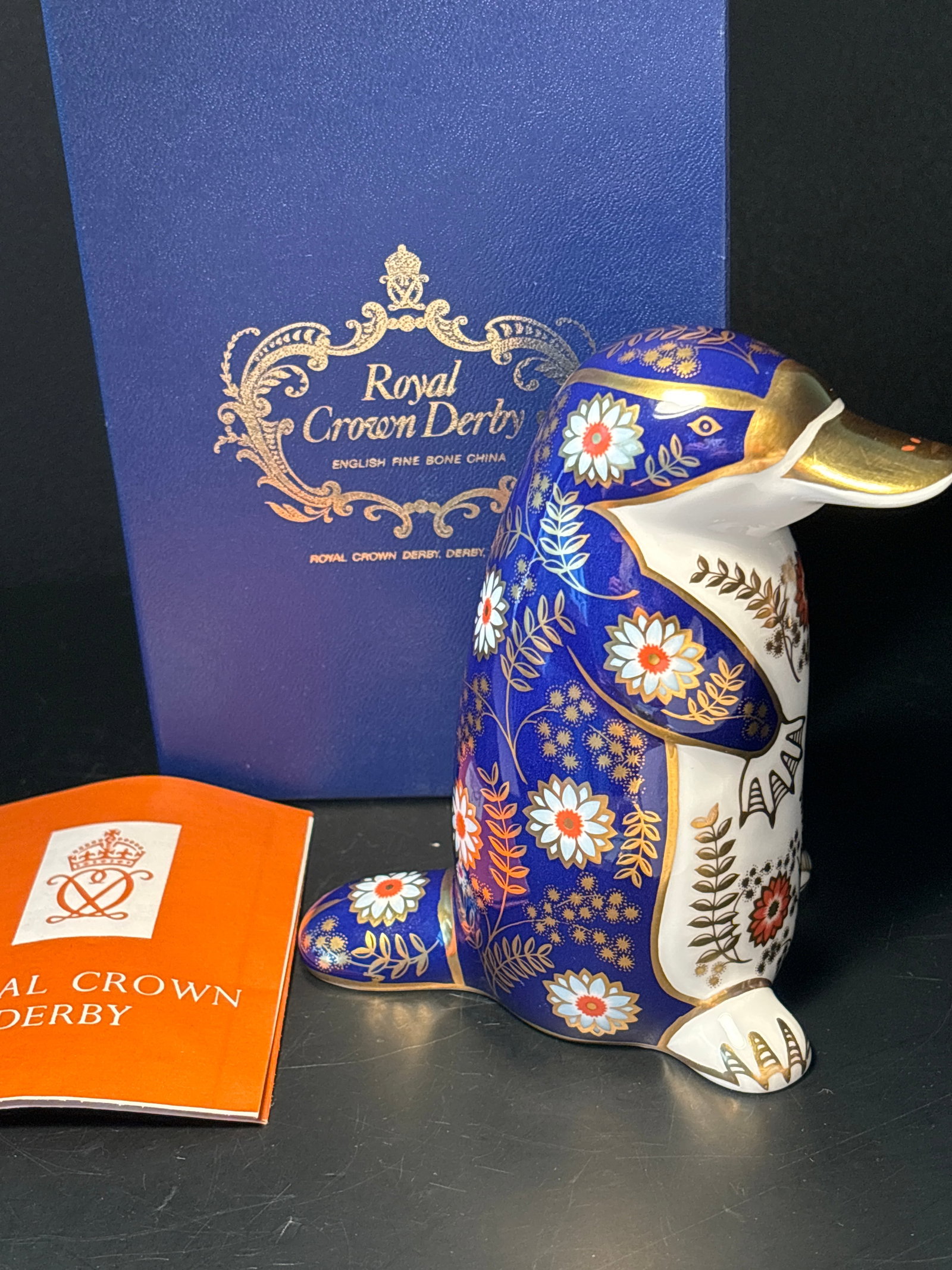 Royal Crown Derby 5&1/4 English bone china platypus statue paperweight, gold stopper: Royal Crown Derby 5&1/4 English bone china platypus statue in box.Gold stopper on the bottom. With original box.Very good condition