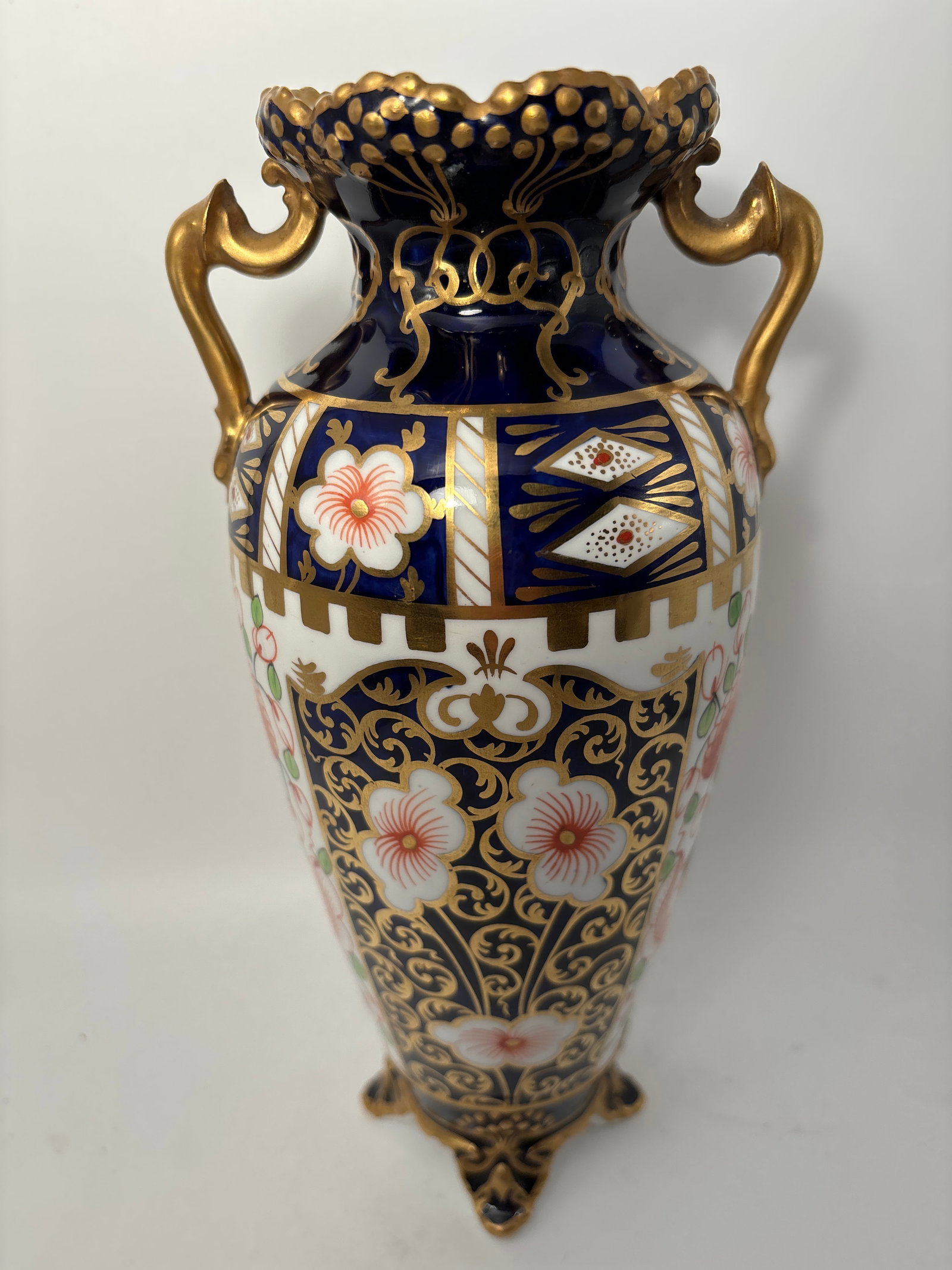 Very nice Imari pattern English china 9&1/4 inch 2 handled vase: Royal Crown Derby Imari pattern English china 9&1/4 inch vase. Twin opposing handles with hand painted gold enamel accents. good condition.