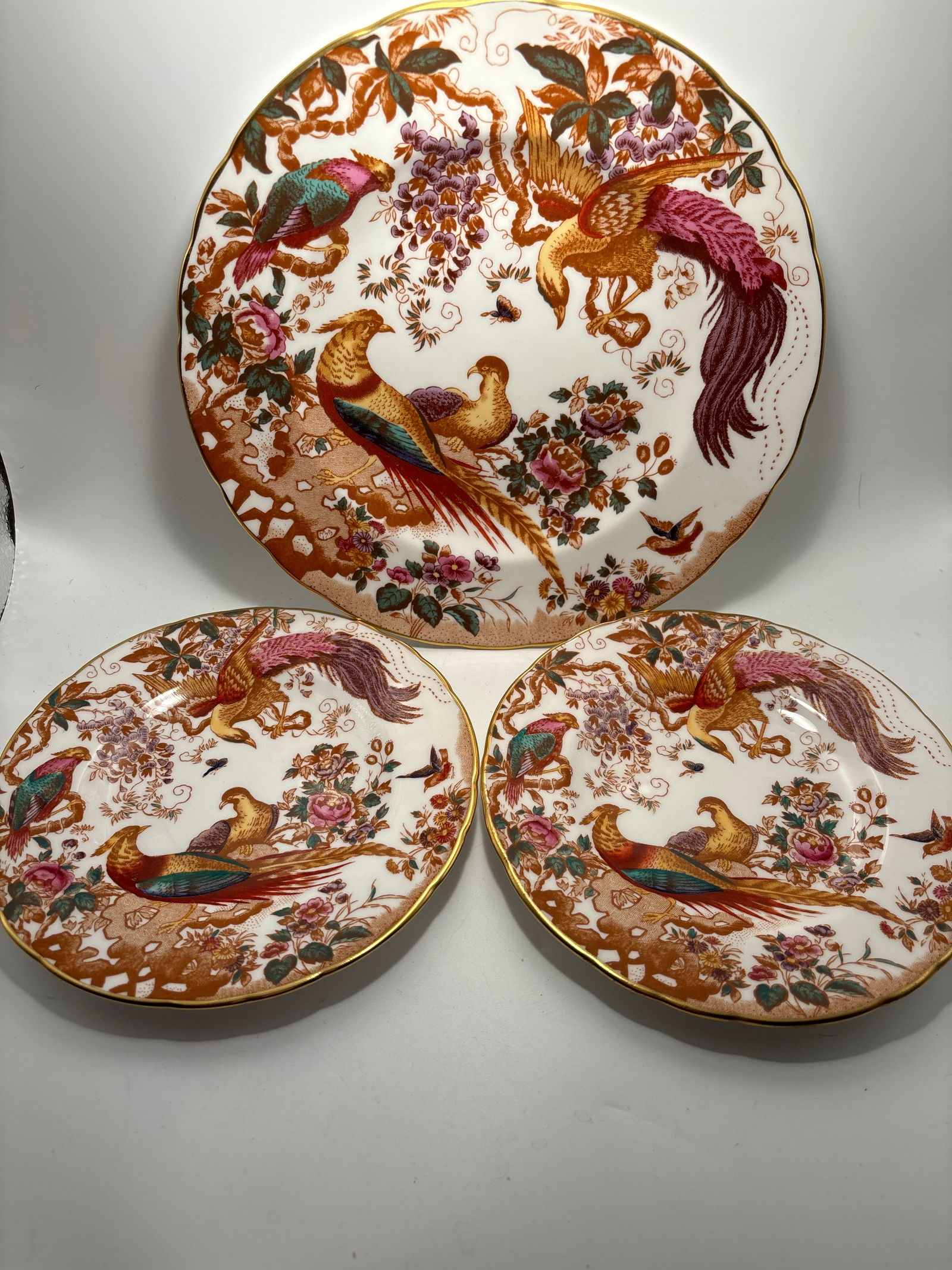 THREE Olde Avebury Royal Crown Derby plates, 1 8&1/2 & pair 6&1/2 inch side dishes: Group of three (3) Olde Avebury Royal Crown Derby plates including one 8&1/2 inch and a pair of 6&1/2 inchside dishes.Very colorful hand painted gold enamel accents. Very good condition.