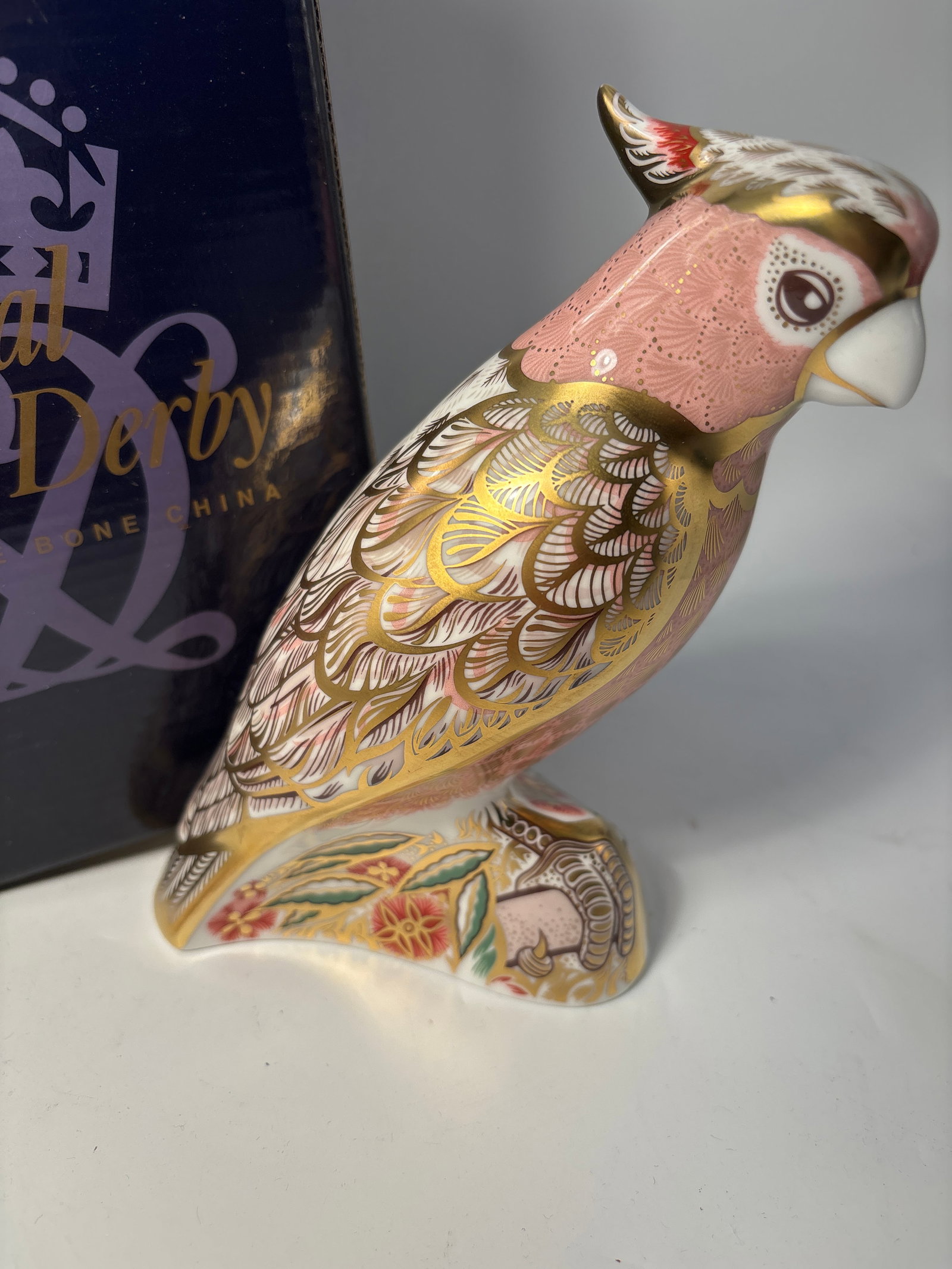 2003 limited edition Cockatoo Royal Crown Derby England 5&1/4 inch paperweight statue: 2003 limited edition Cockatoo Royal Crown Derby England 5&1/4 inch paperweight statue. Pink glazed neck with all over hand enameled gold accents. Original box. Gold stopper.Very good beautiful conditi
