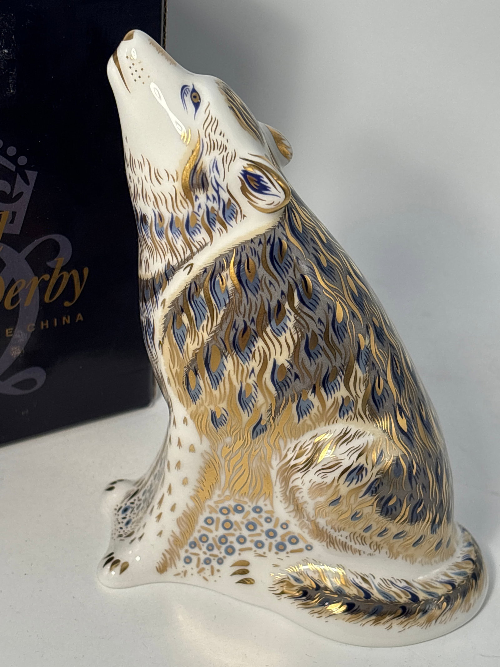 Artist signed 2003 signature edition Wolf Royal Crown Derby England 6inch paperweight statue: 2003 limited edition Wolf Royal Crown Derby England 6 inch paperweight statue. Gray/blue glazed body with all over hand enameled gold accents. Original box. Gold stopper.Very good beautiful condition