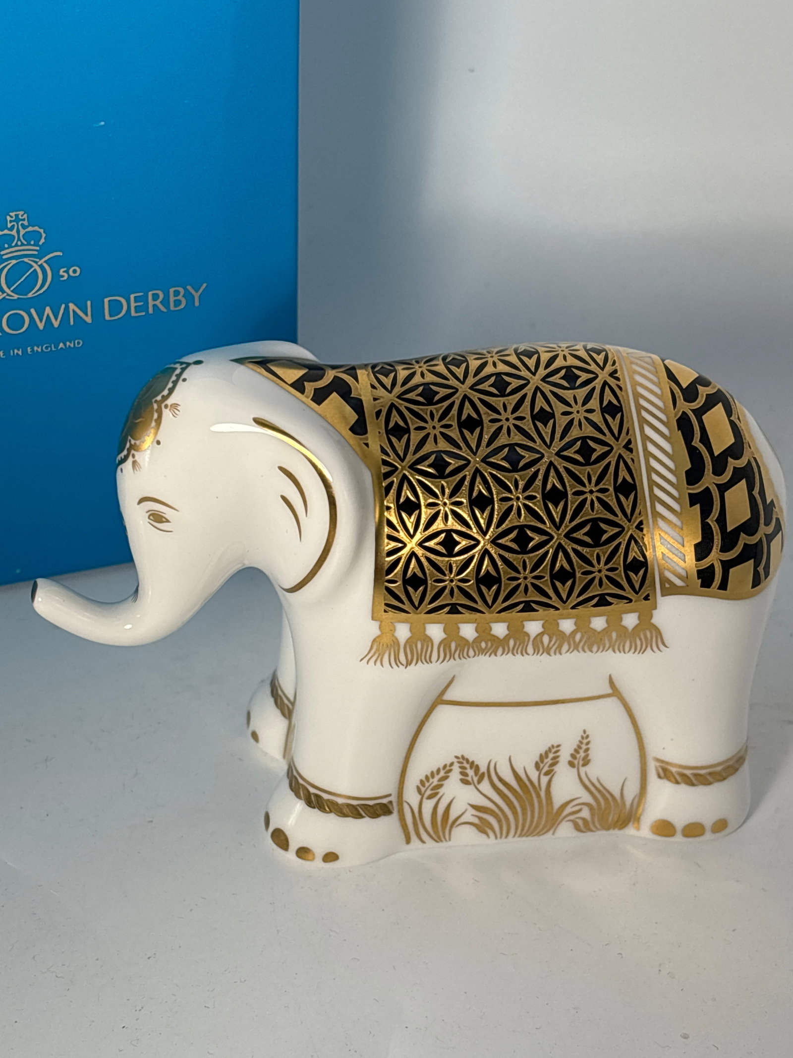 2010 ‘Aura’ infant Elephant, blackRoyal Crown Derby English fine china 4&1/2 inch paperweight: Infant Elephant “Aura” black Royal Crown Derby England 4&1/2inch paperweight statue. Nice hand enameled gold accents. Original box. Gold stopper.Very good beautiful condition