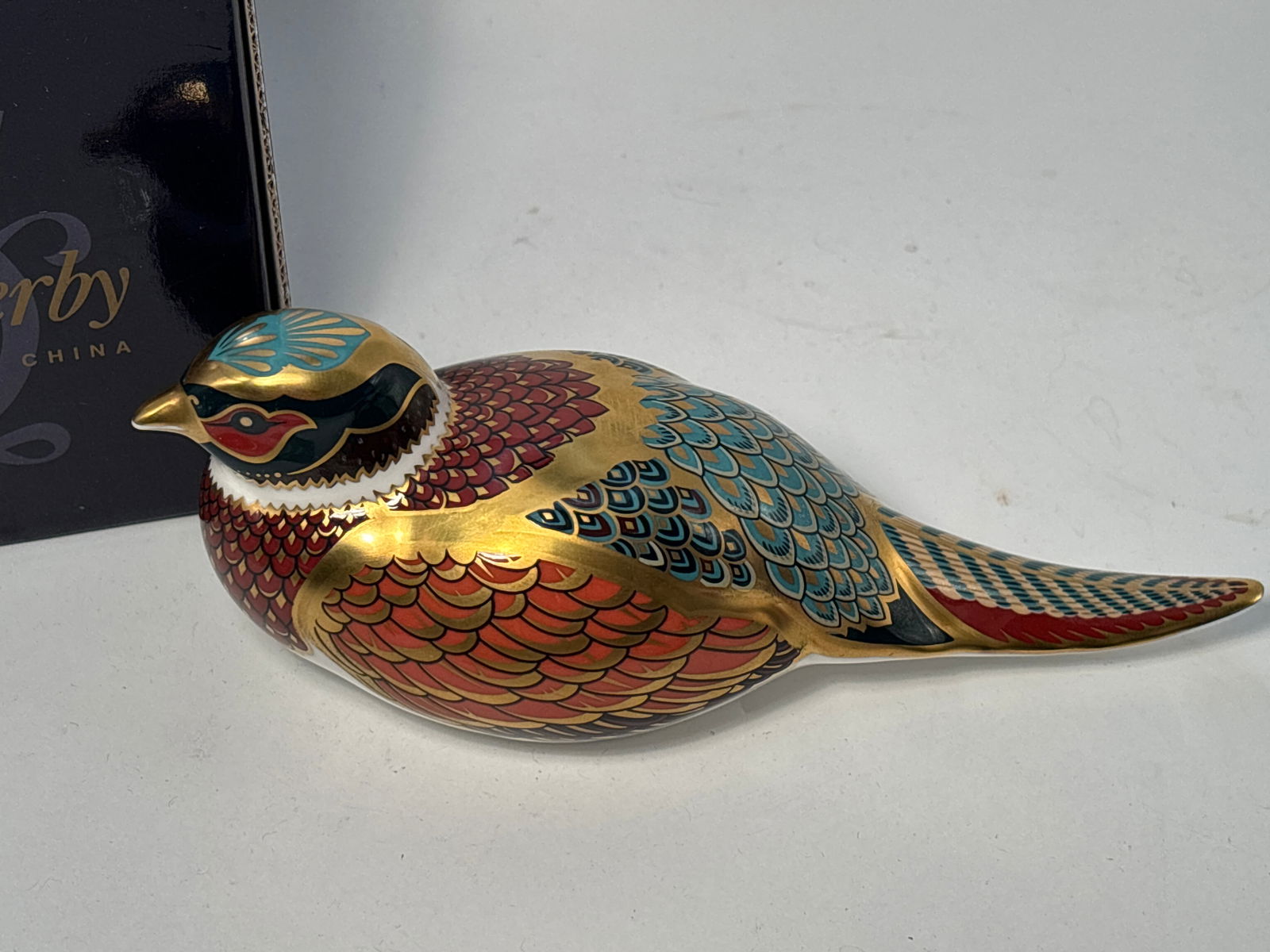 1unique 1998 Collectors Guild Woodland Pheasant Royal Crown Derby English 7inch paperweight: Unique colors 1998 Collectors Guild Woodland Pheasant Royal Crown Derby English 7inch paperweightNice hand enameled gold accents. Gold stopper. Original box. Very good beautiful condition