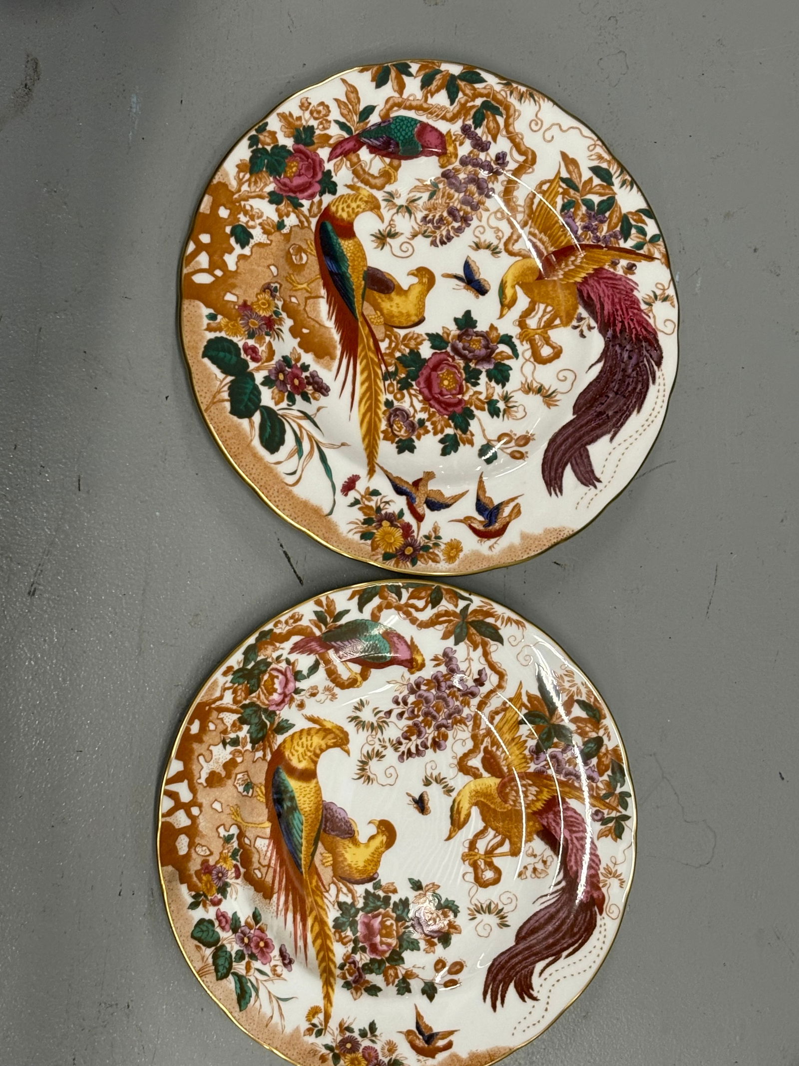 Two similar Olde Avesbury pattern A.73 Royal Crown Derby England8&1/4inch plates: Two similar Olde Avesbury pattern A.73 Royal Crown Derby England plates.Colors are bright and clear on very clean plates. One is Approximately 8&1/4 inches with somewhat shaped design edge and the oth