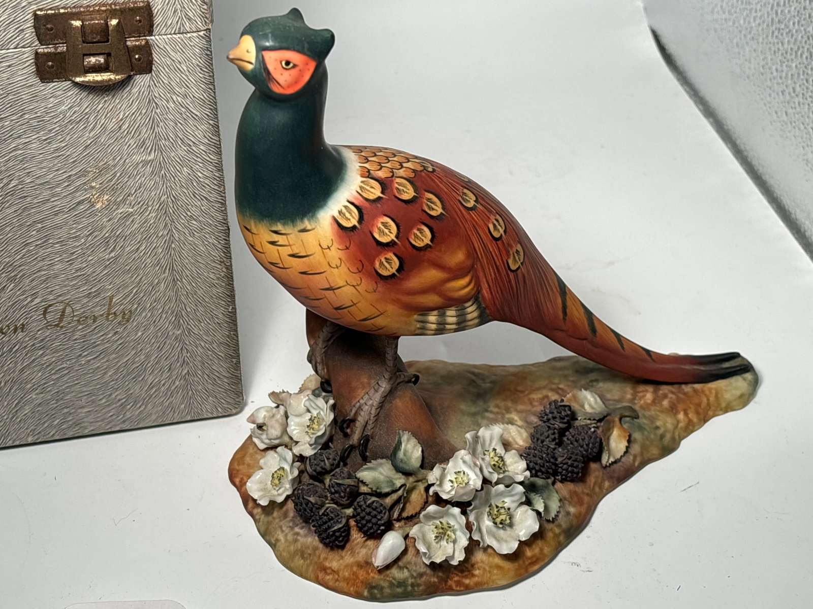 Beautiful big 7&1/2inch Royal Crown Derby matte pheasant settled amongst blackberries flowers: Royal Crown Derby matte pheasant settled amongst blackberries and flowers. In good condition with no obvious faults or damage.Original box. Very good condition, no chips, cracks, etc.