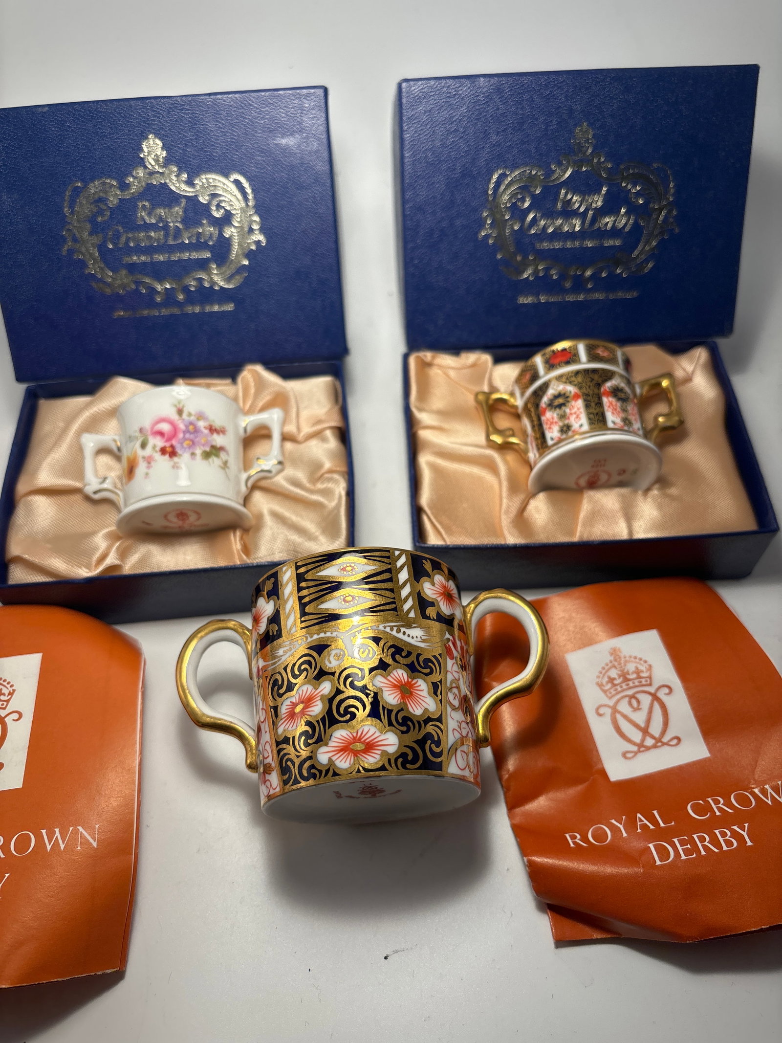 Three Royal Crown Derby small 2 handle loving cups: Three Royal Crown Derby loving cups. Imari pattern 2451 is 2x2inches, not including handles (no box). Imari 1128 is 1&1/4x 1&1/4 inches and comes in original fitted box. Derby Posies is 1&1/4x 1&1/4 i