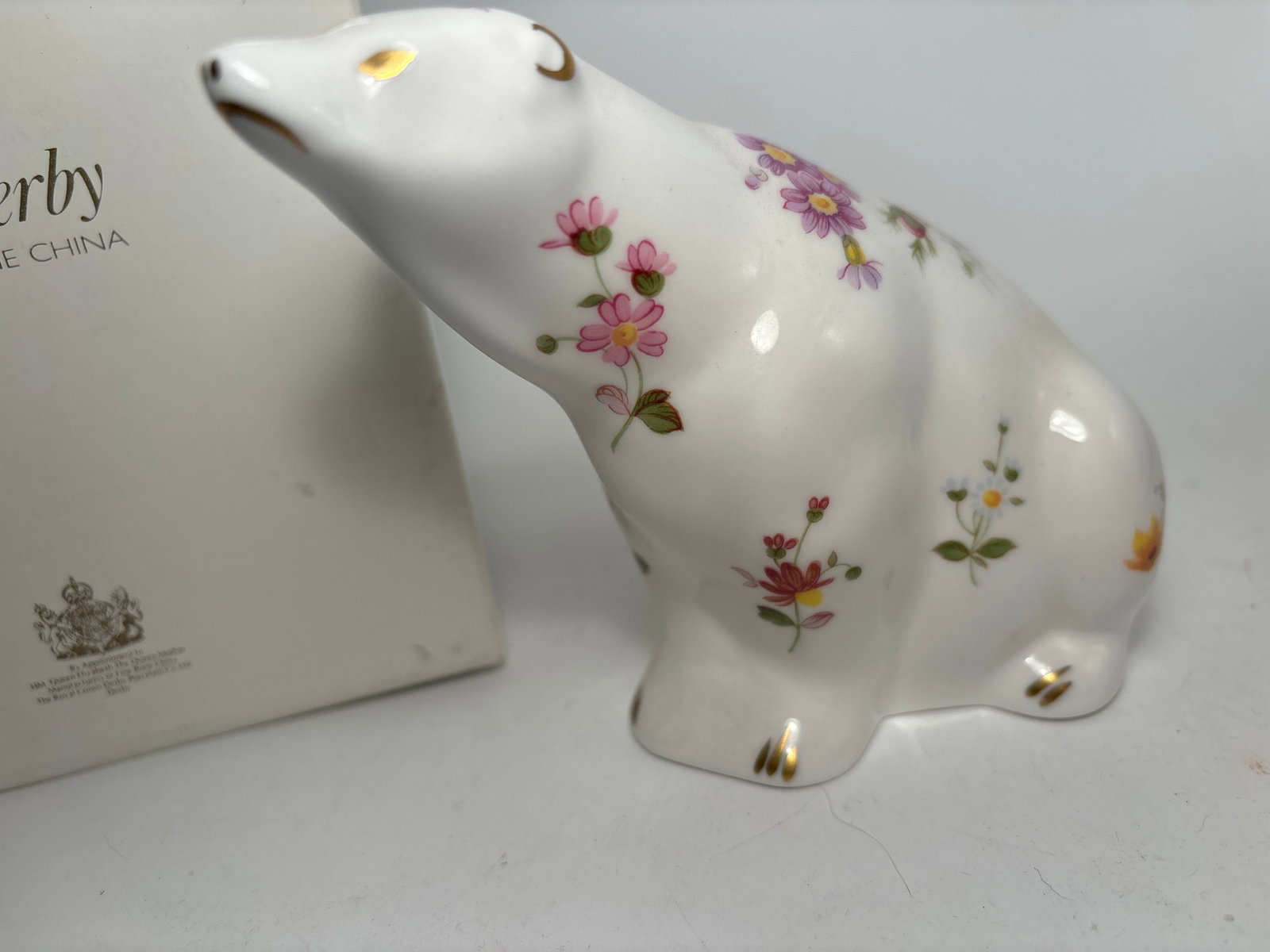 Derby Posies Polar Bear Royal Crown Derby 5 paperweight statue: Derby poise Royal Crown Derby polar bear 5 inch statue. With original box. Silver stopper.Very good condition, no chips, cracks, etc.