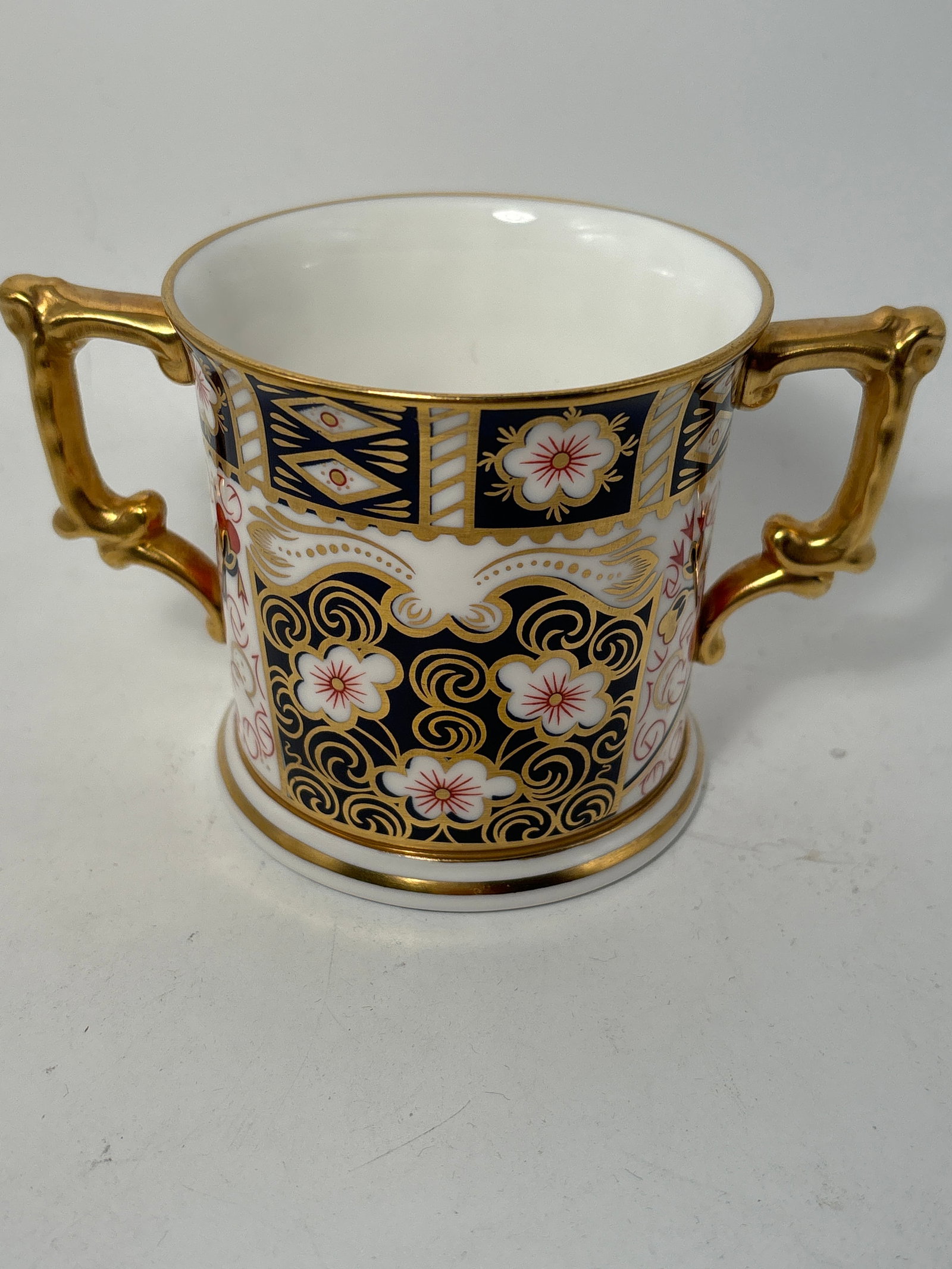 Imari 2451 pattern 2 handled loving cup Royal Crown Derby 3inch cup: Imari 2451 pattern 2 handled loving cup Royal Crown Derby fine China 3inch high by wide (not including handles). Very good condition, no chips, cracks, etc.