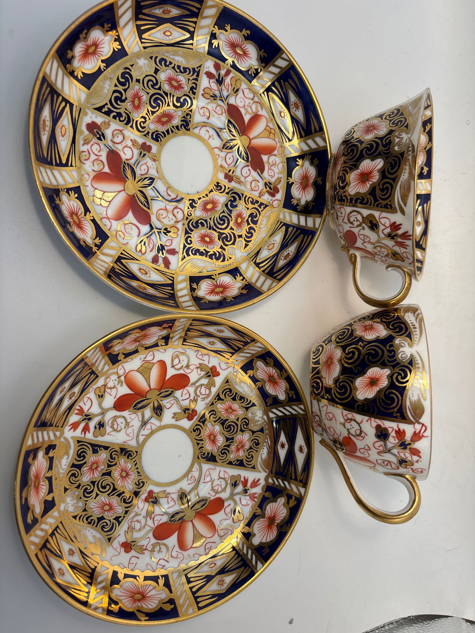 Two similar Imari 2451 pattern Royal Crown Derby tea cups with saucers: Two similar Imari 2451 pattern Royal Crown Derby plates. Approximately 3&1/2 across top & almost 2inches high. Saucers are 5&1/2 inches across Both in very good condition