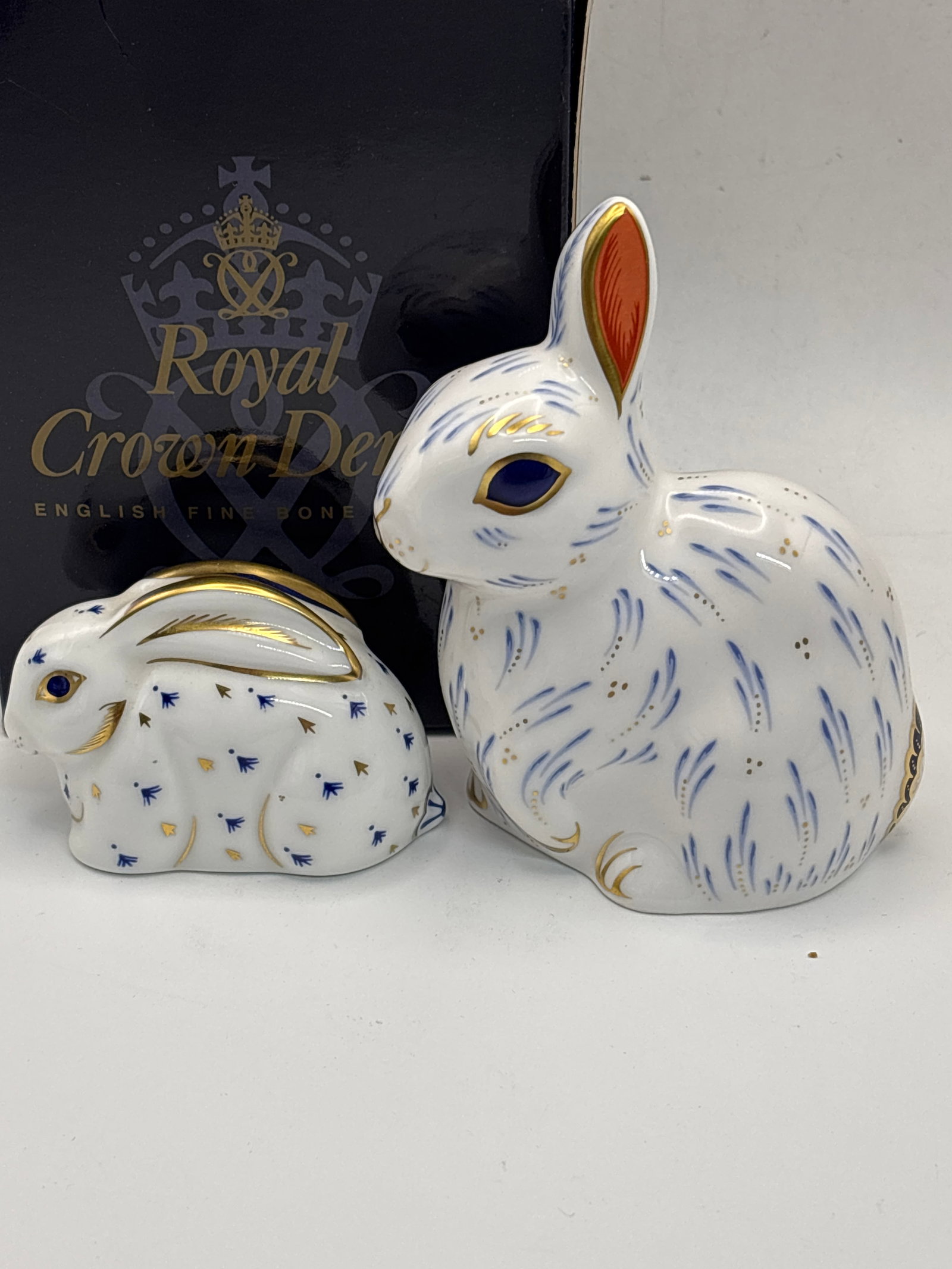 2 Rabbit Royal Crown Derby paperweights including Model John Ablitt Snowy Rabbit: Design By June Branscombe 2 Rabbit Royal Crown Derby paperweights including Model John Ablitt Snowy Rabbit. Good stopper. With box. 4&1/8 inch high.Other rabbit is 2 inches, silver stopper, no box.Ver