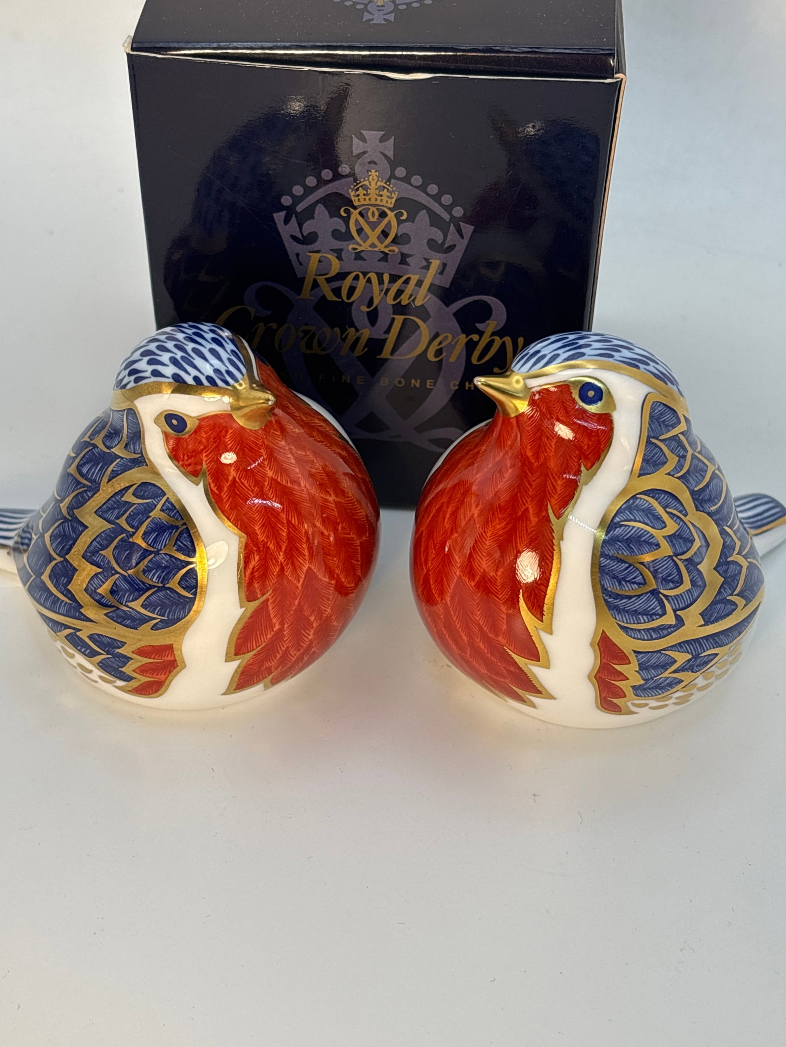 2 Robin form Royal Crown Derby English fine china paperweights: 2 Rabbits Royal Crown Derby paperweights. Both silver stopper. One With box. About 3x3&12 inches. Very good condition