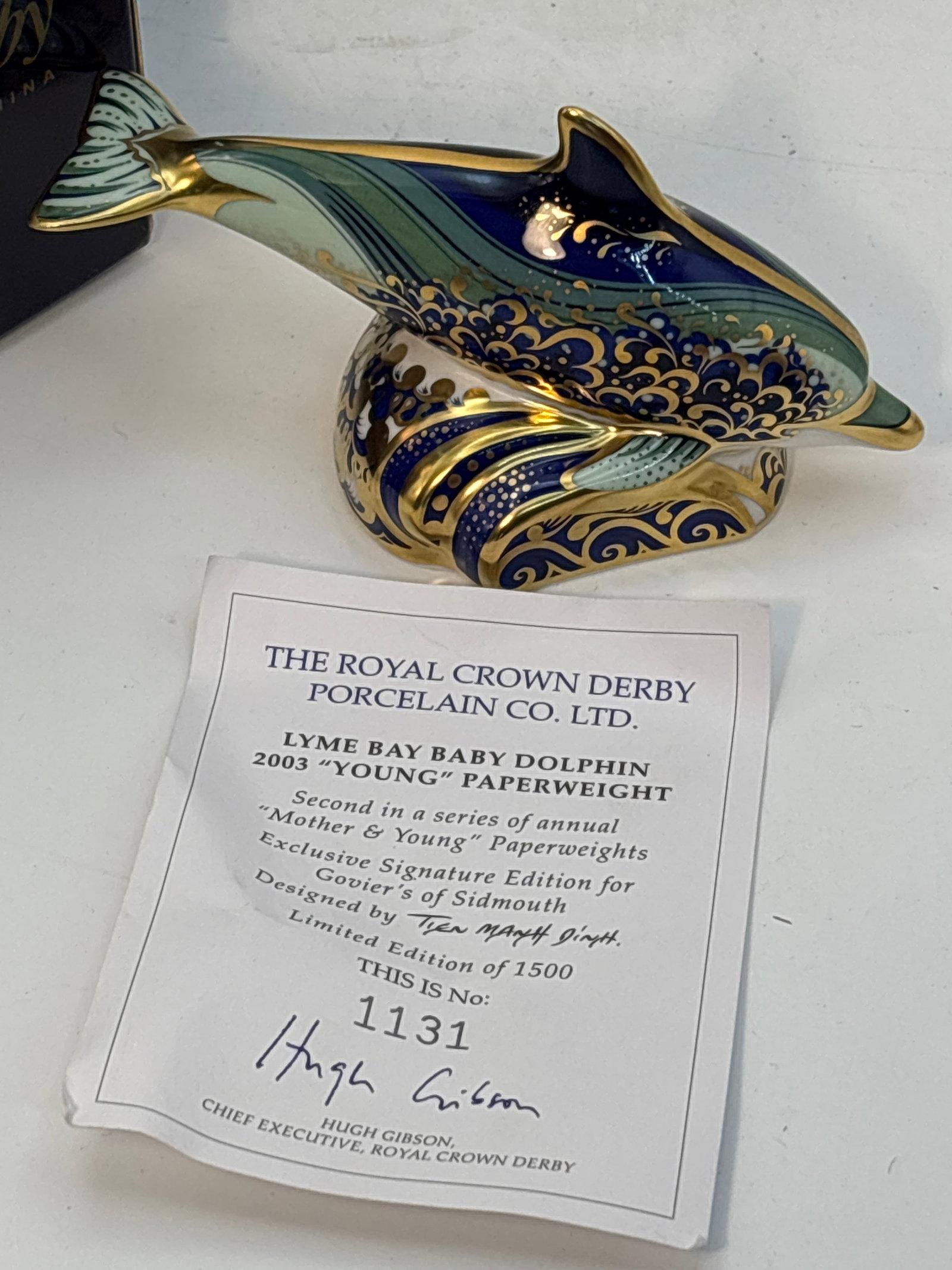 2002 Govier’s signature edition ‘Lyme Bay baby Dolphin’ Royal Crown Derby 4&3/4 inch: 2002 Govier’s signature edition ‘Lyme Bay baby Dolphin’ Royal Crown Derby 4&3/4 inch paperweight.Gold stopper. With COA. With box.Very good condition; no chips, cracks, etc