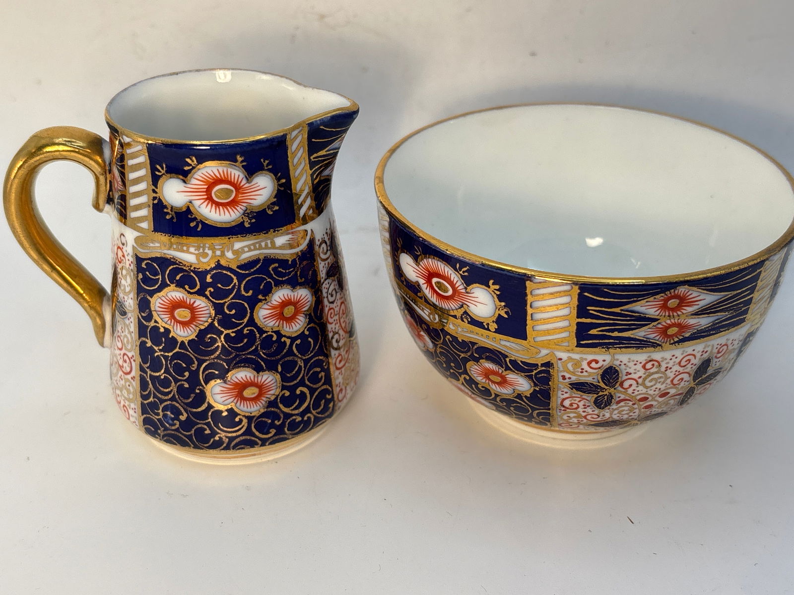 Unmarked Old Imari English bone china open sugar and creamer: Unmarked Old Imari English bone china open sugar and creamer.Creamer is 3&1/4high. & sugar is 3&3/4 wide.Age line on bottom of sugar.Very good condition; no chips, cracks, etc