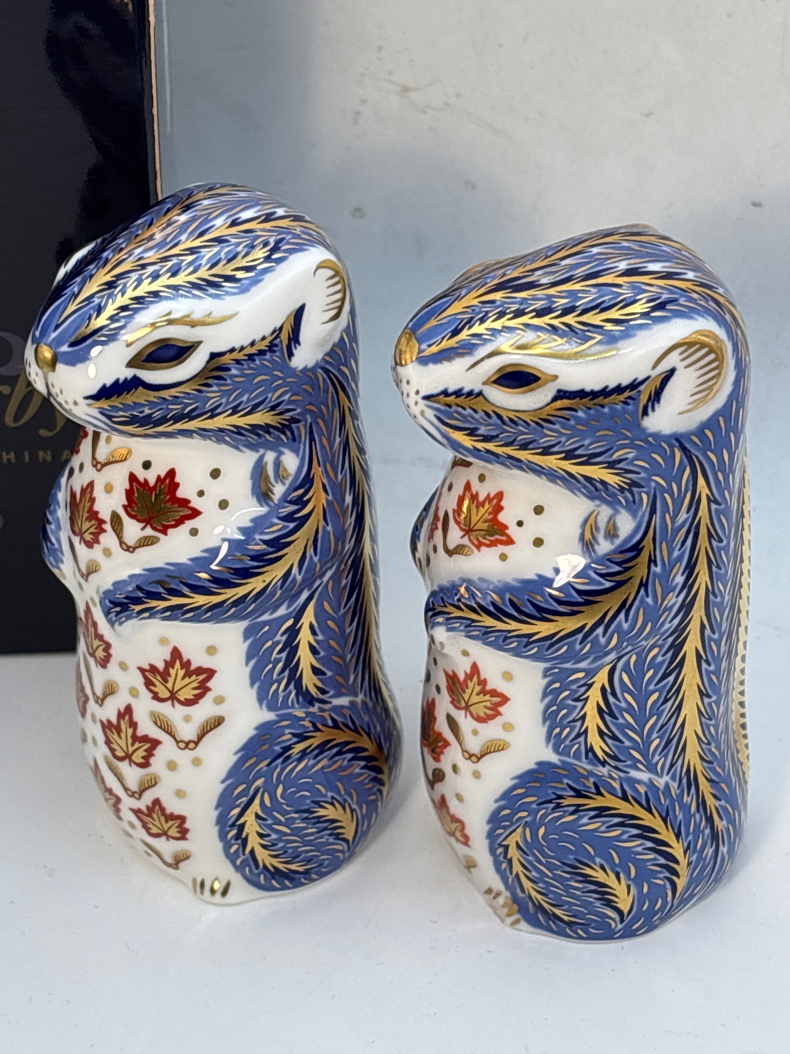 Two Chipmunks RoyalCrown Derby Imari 4&1/2inch paperweights: Two chipmunks Royal Crown Derby 4&1/2inch paperweights.Silver stopper & one with no stopper.One with box.Very good condition; no chips, cracks, etc