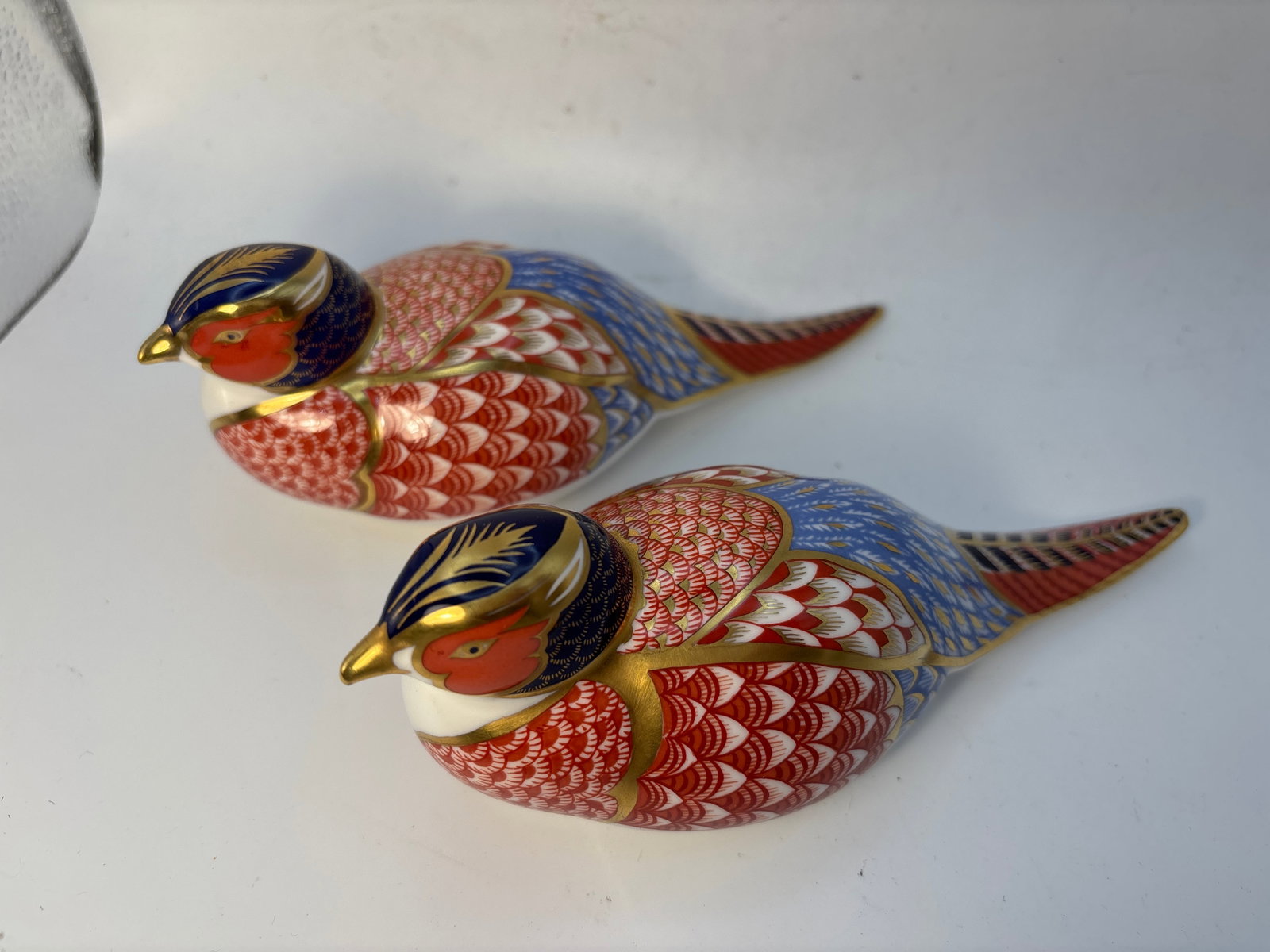 Two 7 inch pheasants RoyalCrown Derby Imari paperweights: Two pheasants Royal Crown Derby 7 inch long paperweights. Gold stopper & one with no stopper. No box.Very good condition; no chips, cracks, etc