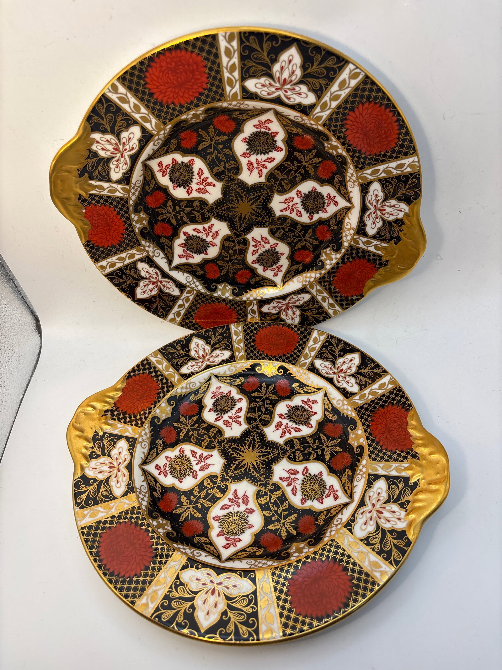 Two Imari Chrysanthemum pattern ‘Abbeydale’Royal Crown Derby 9&3/4 in serving plates: Two Imari Chrysanthemum pattern ‘Abbeydale’Royal Crown Derby 9&3/4 in serving plates.Opposing heavy gold enamel handles. Very clean with no chips, cracks, etc.