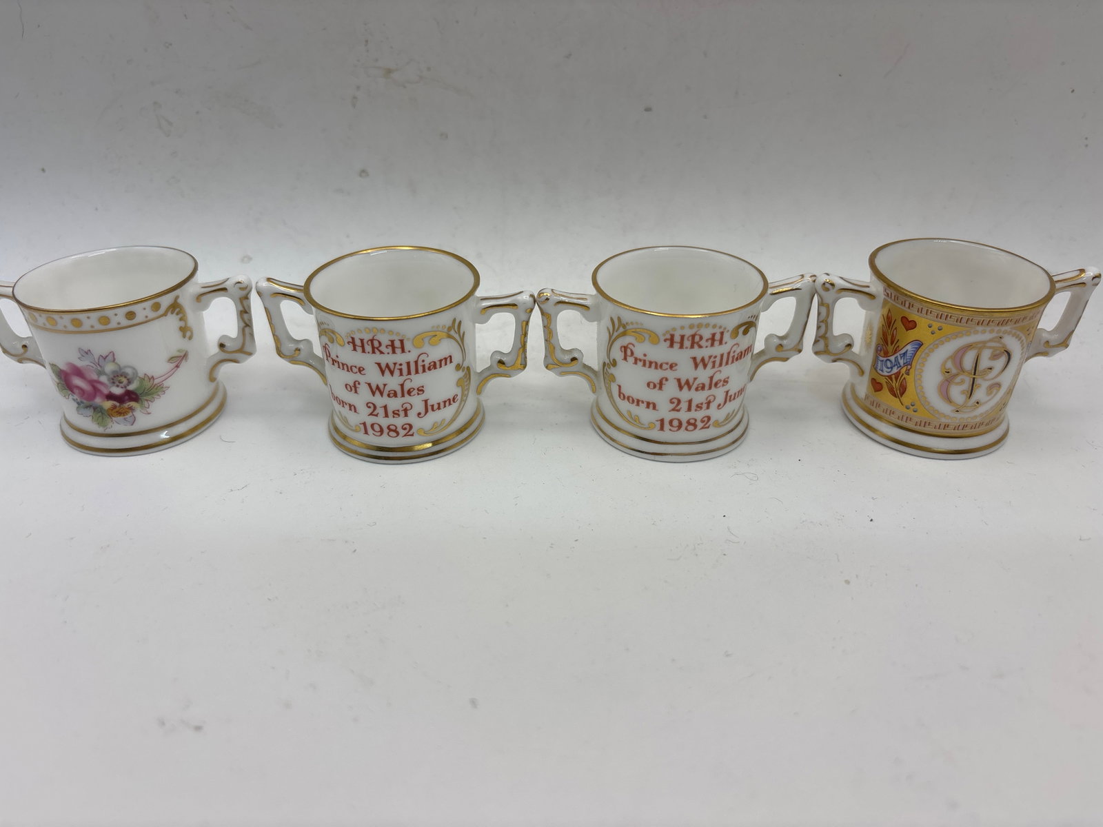 Four mini loving cups Royal Crown Derby English china: Four 1 inch mini loving cups Royal Crown Derby English fine china .one 50 Royal Golden Wedding Anniversary, 2 Prince William & a Derby Posies.No chips, cracks, etc.