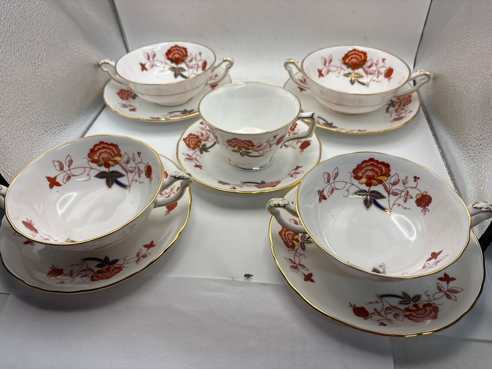 Four soups & a tea cup Bali A.1100 pattern Royal Crown Derby china: Four soups and one tea cup Bali A.1100 pattern Royal Crown Derby the double handled soups are 2 high by 4&3/4 inches across ( not including handles) and saucers are 6&1/4 inches.No chips, cracks, etc.
