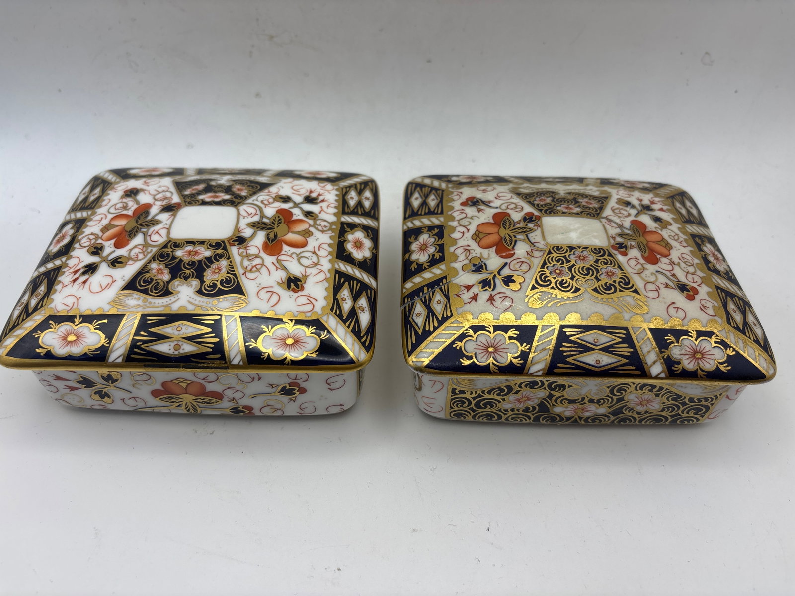 Two Imari 2451 pattern Royal Crown Derby 4&1/2inch covered boxes;1 as is: Two Imari 2451 pattern Royal Crown Derby 4&1/2inch covered boxes;1 as is.One with no chips, cracks, etc