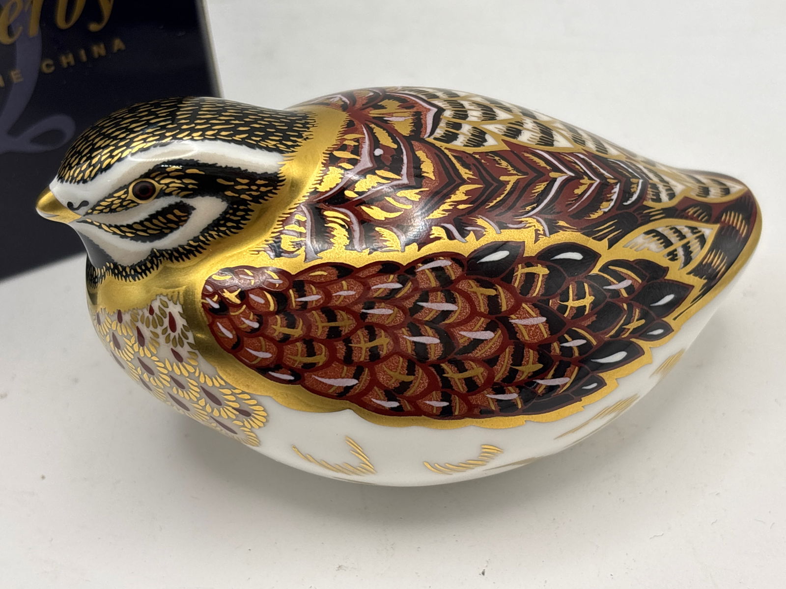 Artist signed ‘Dappled Quail’ form Royal Crown Derby 4&1/2 inch paperweight: Artist signed ‘Dappled Quail“ Royal Crown Derby 4&1/2 inch paperweight, gold stopper. With box. Very Good condition