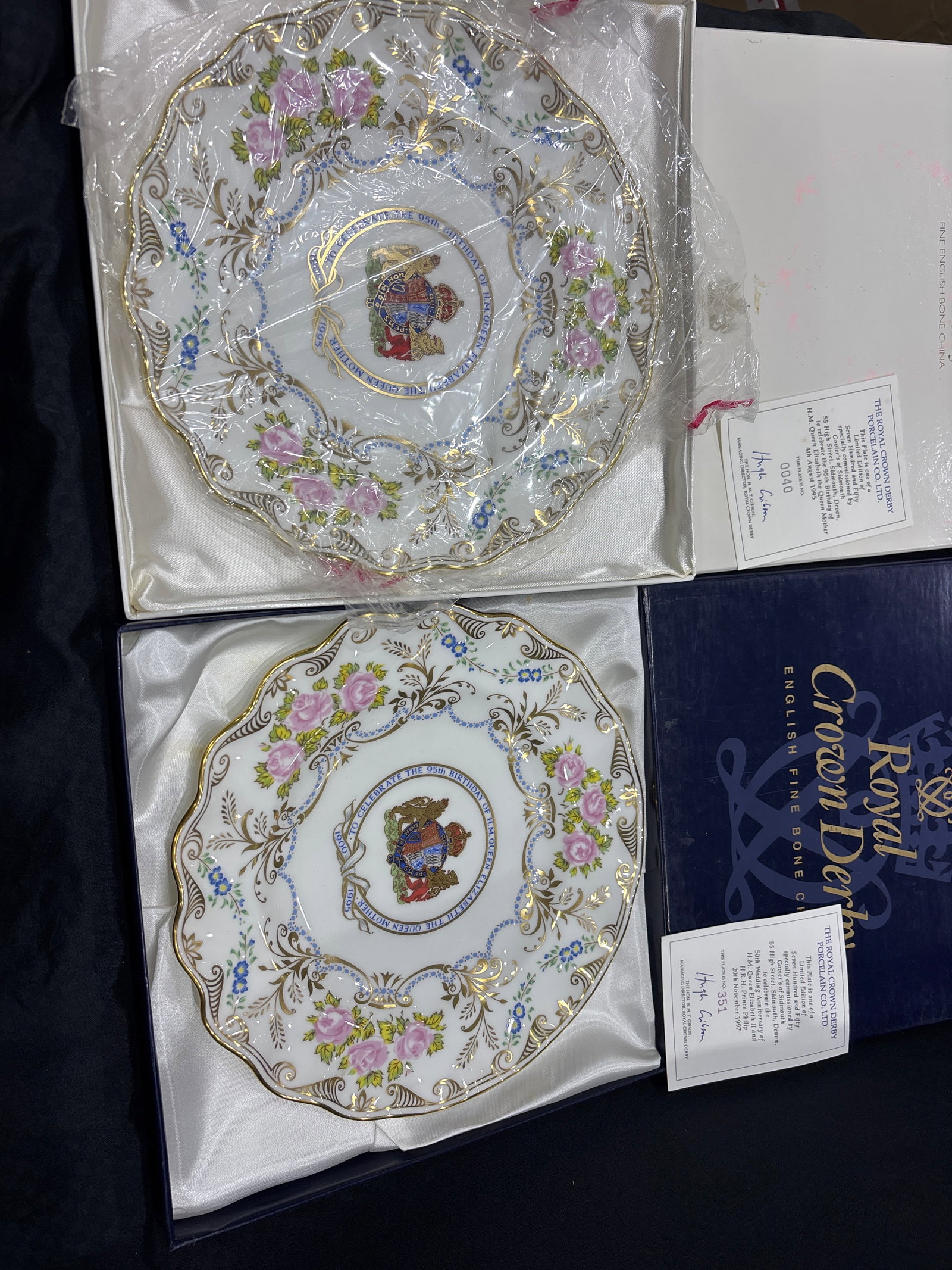 Wavy edge Two Exquisite Queen Elizabeth 95th Birthday Royal Crown Derby 8&1/2inch plates: Two Exquisite Queen Elizabeth 95th Birthday Royal Crown Derby 8&1/2inch plates. Both with original fitted boxes. Very good condition with no chips, cracks, etc. the white box has wear.