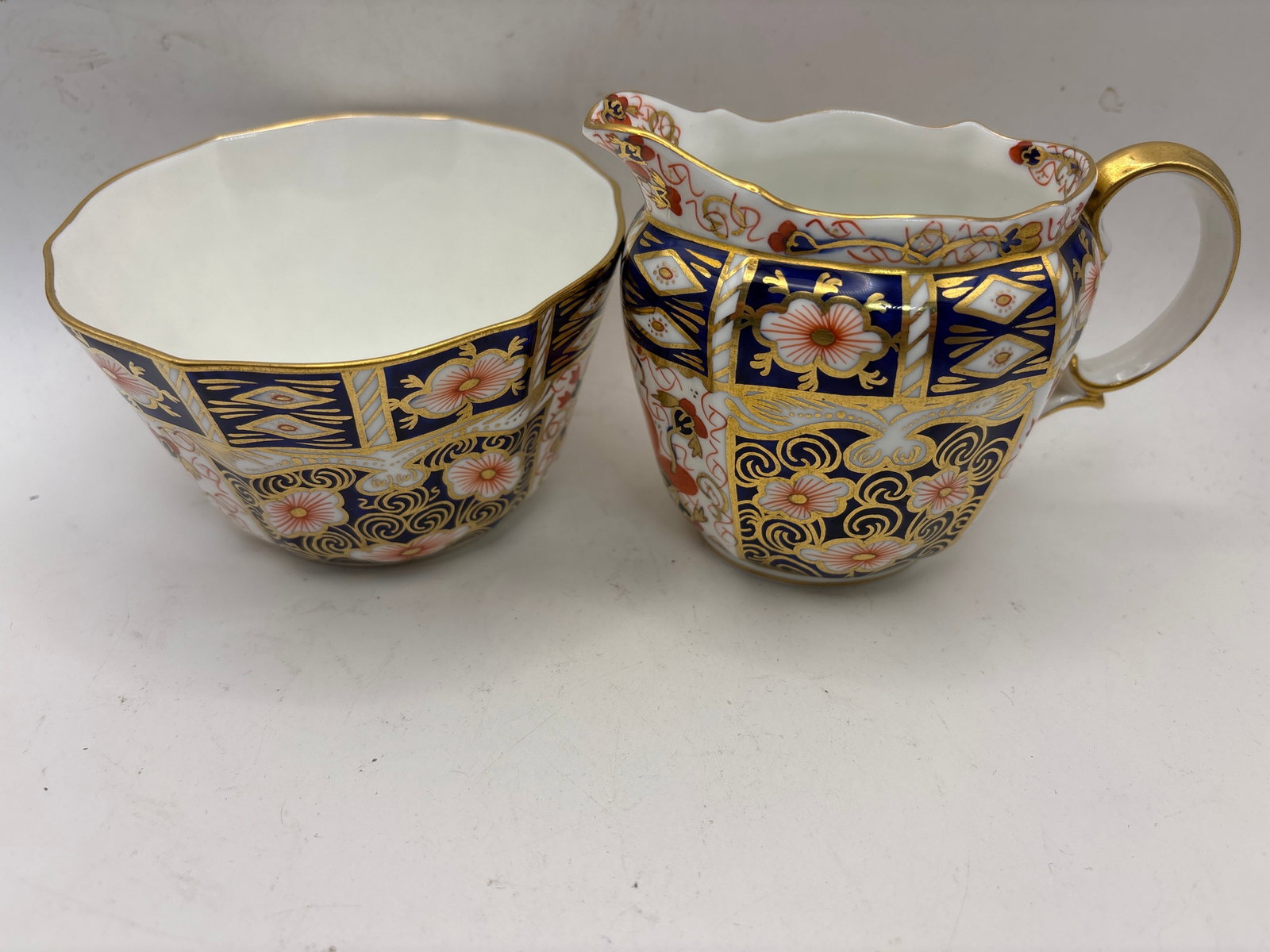Imari 2451pattern Royal Crown Derby creamer & open sugar: Imari 2451pattern Royal Crown Derby creamer & open sugar.The sugar is 4&1/4 across top & 2&1/4 high, creamer is 3&3/4 inches.Great colors and wonderful gold accents. All in excellent condition
