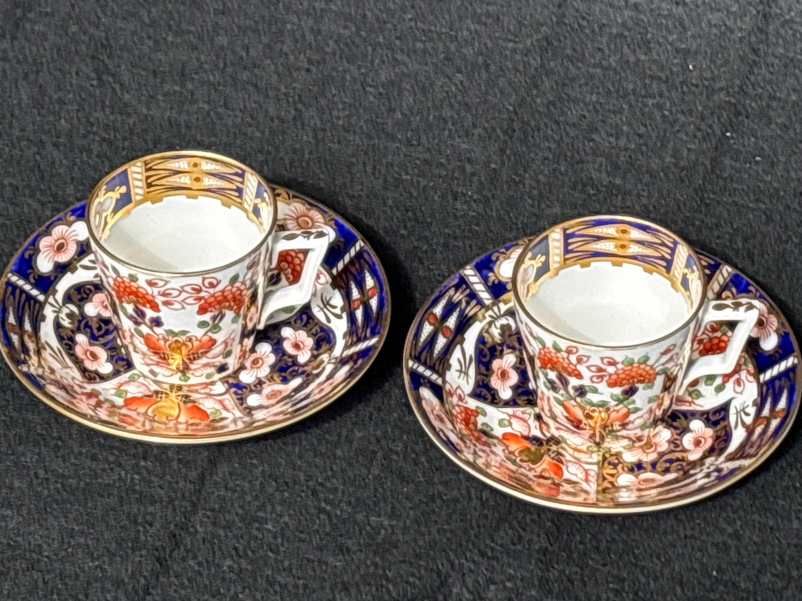 Pair antique old Imari pattern Royal Crown Derby cups with saucers: Pair antique old Imari pattern Royal Crown Derby cups with saucers. Cups are a little over 2 inches high & wide and saucers are under 5 inches.Very good condition