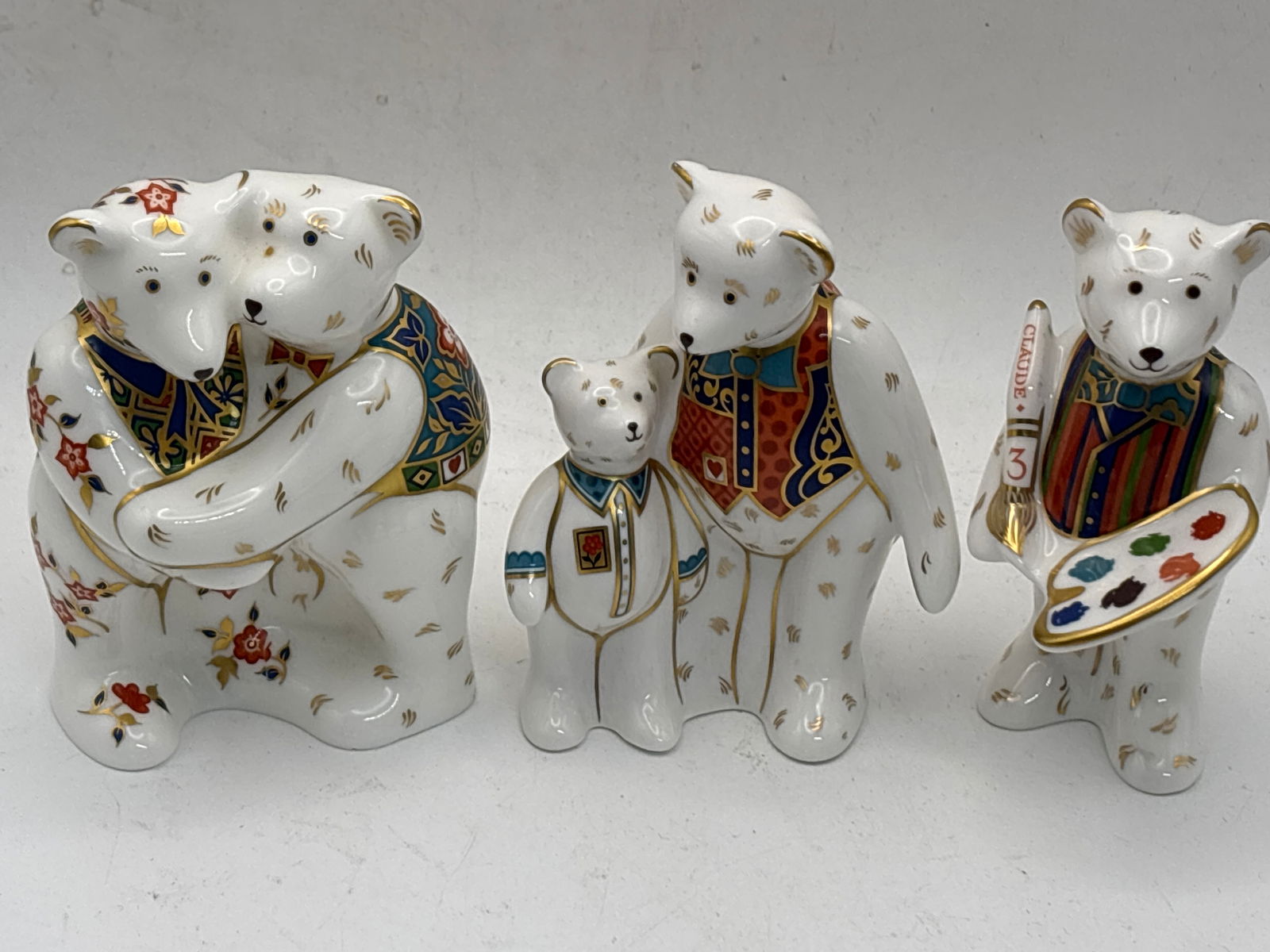 Claude the artist, Daddy & George& Bear Hug Royal Crown Derby paperweights: Claude the artist, Daddy & George& Bear Hug Royal Crown Derby paperweights. No box, 4”high. These were produced without stoppers. Very good condition
