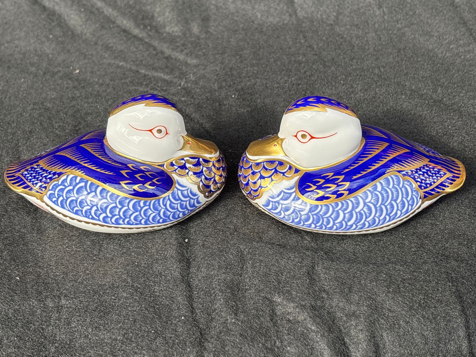 Two Duck form Royal Crown Derby England 4&1/2 inch paperweights: Two ducks Royal Crown Derby 4&1/2 inch paperweights. Silver stoppers. No box. Like new