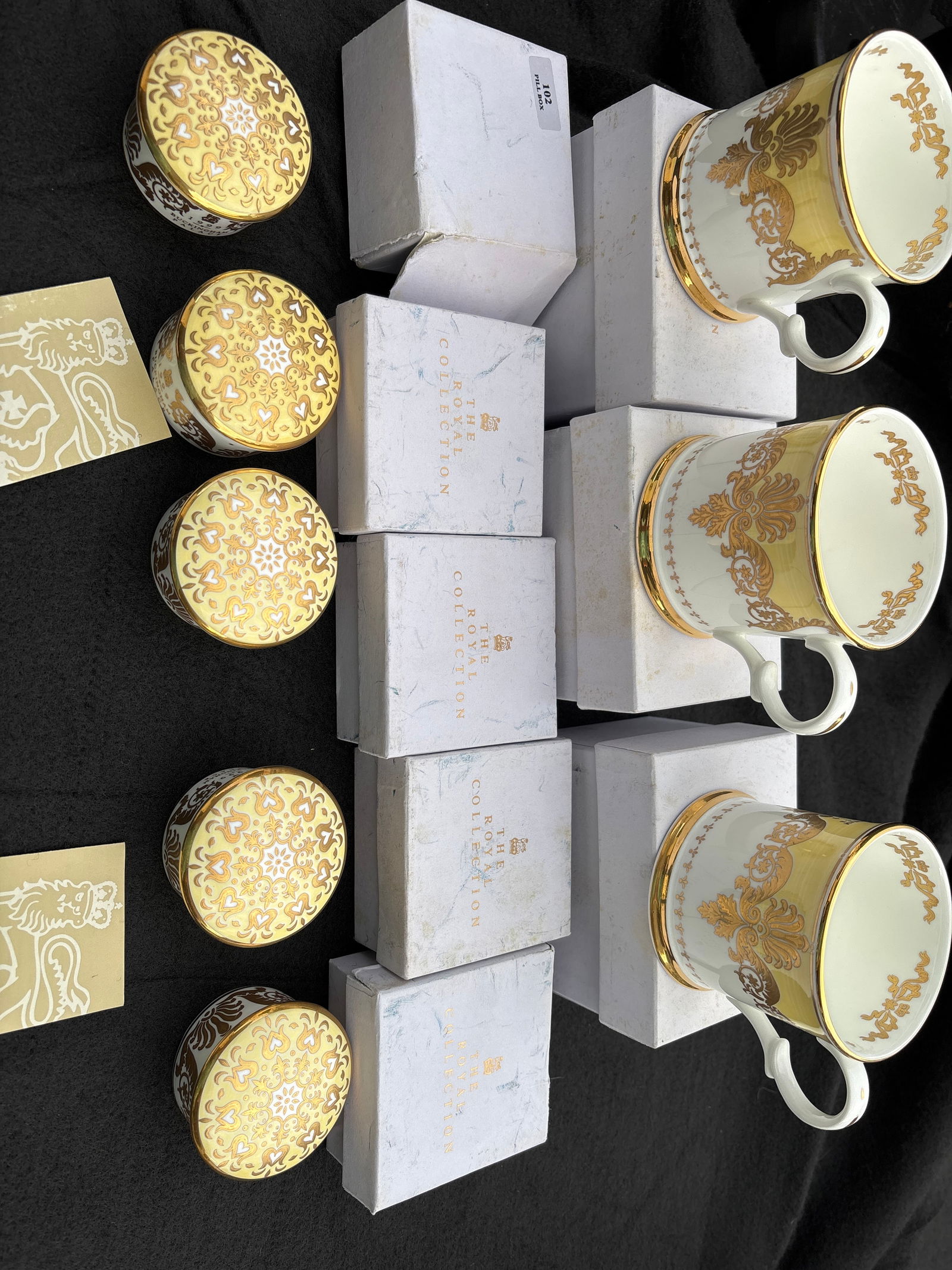 Eight Buckingham Palace fine English bone china mugs & boxes: Eight Buckingham Palace fine English bone china mugs & trinket boxes. The mugs are Approximately 3 inches tall and boxes are 1&1/4 by 2&1/2 inch. All have original boxes ( boxes show signs of wear). C