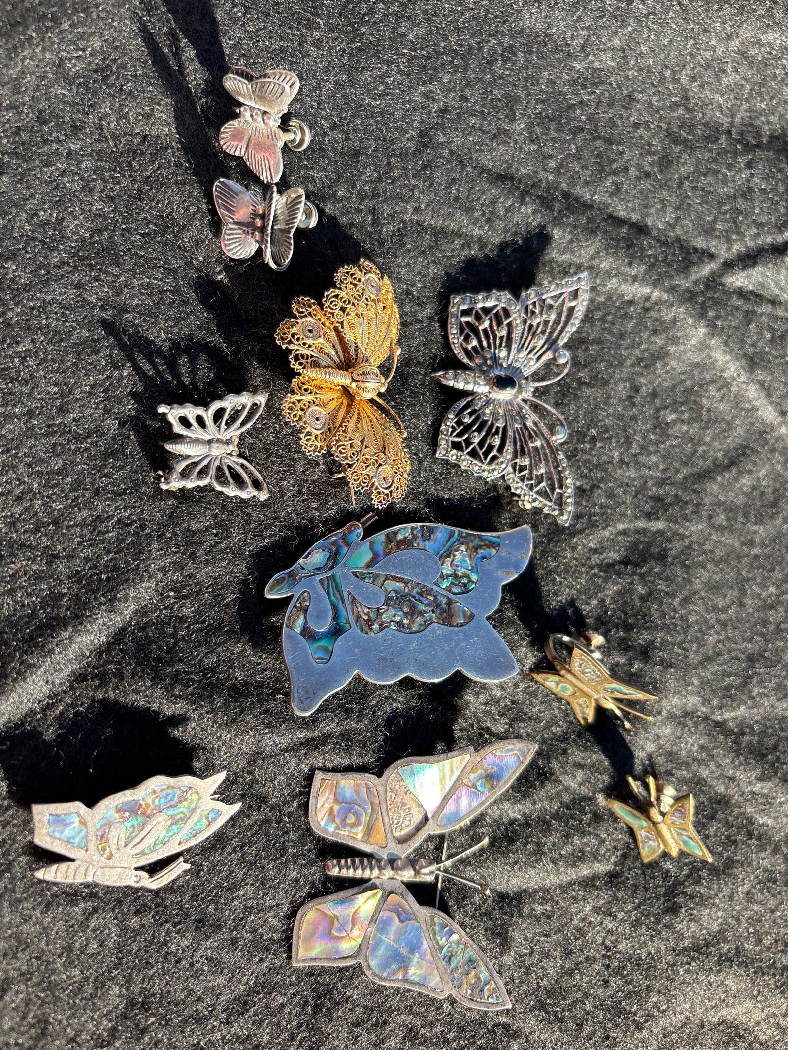 Group of ten similar sterling silver butterfly form jewelry; 55grams: Group of ten similar sterling silver butterfly form jewelry; 55grams. Two small pair earrings, three abalone decorated (1 damaged) and two others.