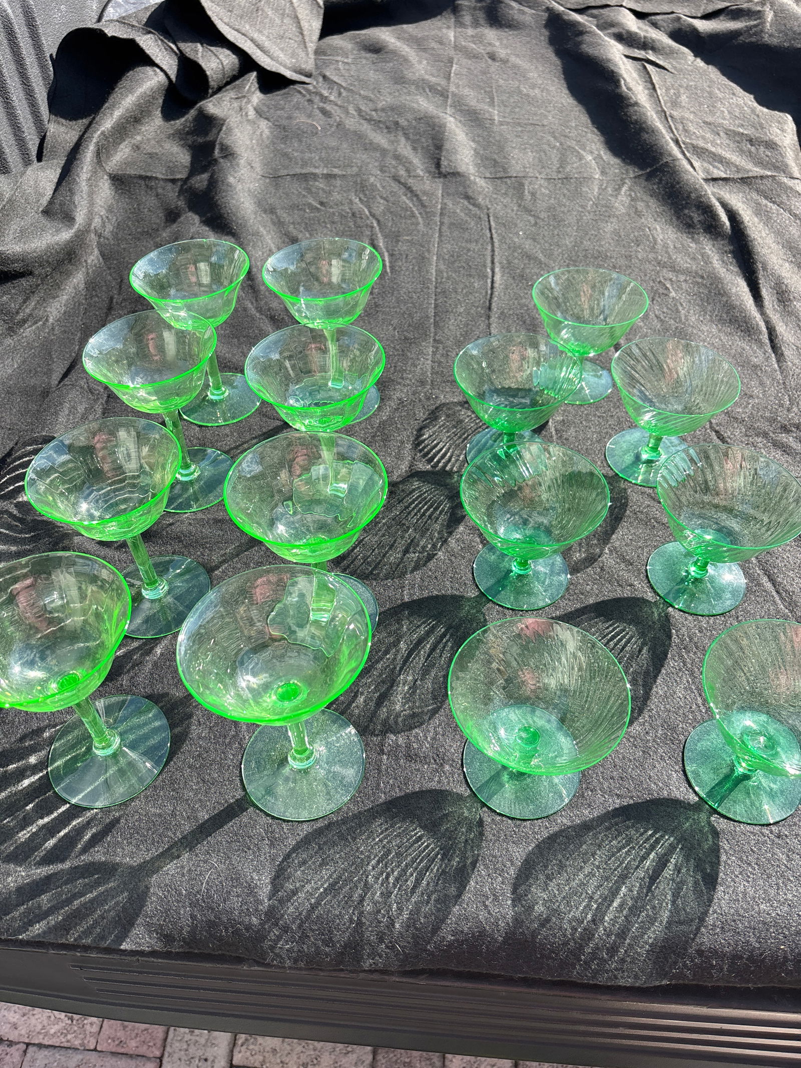 Group of fifteen antique depression era Vaseline/uranium glasses, some chips: Set of 9 antique depression era Vaseline/uranium glasses. Eight 5&1/4” champagnes have Vertical subtle line design. All the smaller ones with swirl design 3&1/4 inch very good with no chips. Fiv